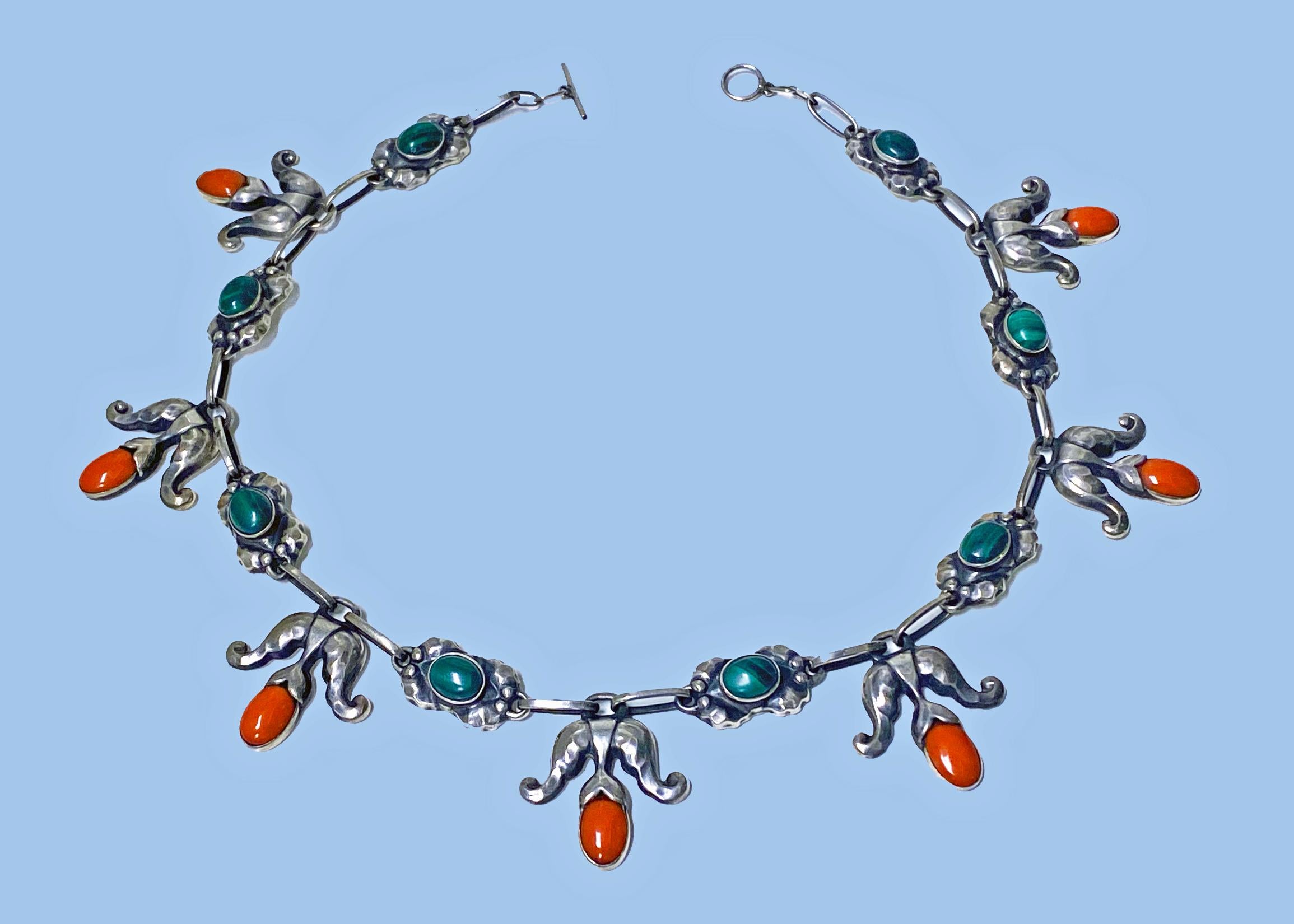 Georg Jensen exceptionally rare design Sterling Malachite and coral color Necklace C.1933, design No. 9. The Necklace composed of leaf and drop bud motifs each bezel set with a cabochon coral color, the facetted leaf’s each with green oval