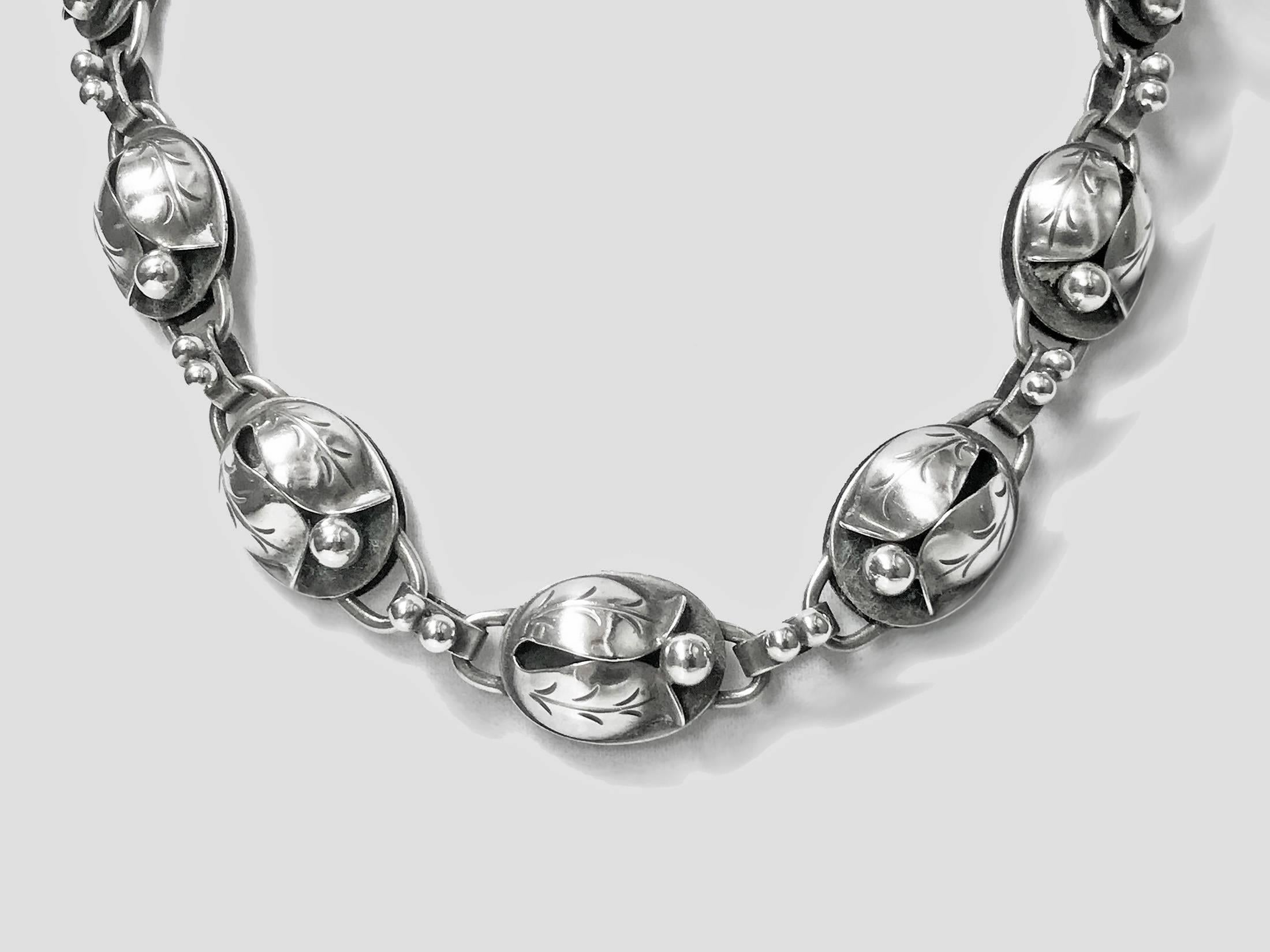 Georg Jensen Sterling matching Necklace and Bracelet, C.1940.The Necklace and Bracelet, convertible to longer necklace, with hinged open stylised bud blossom links, plain polished bud links between, Georg Jensen hand wrought Sterling USA marks to