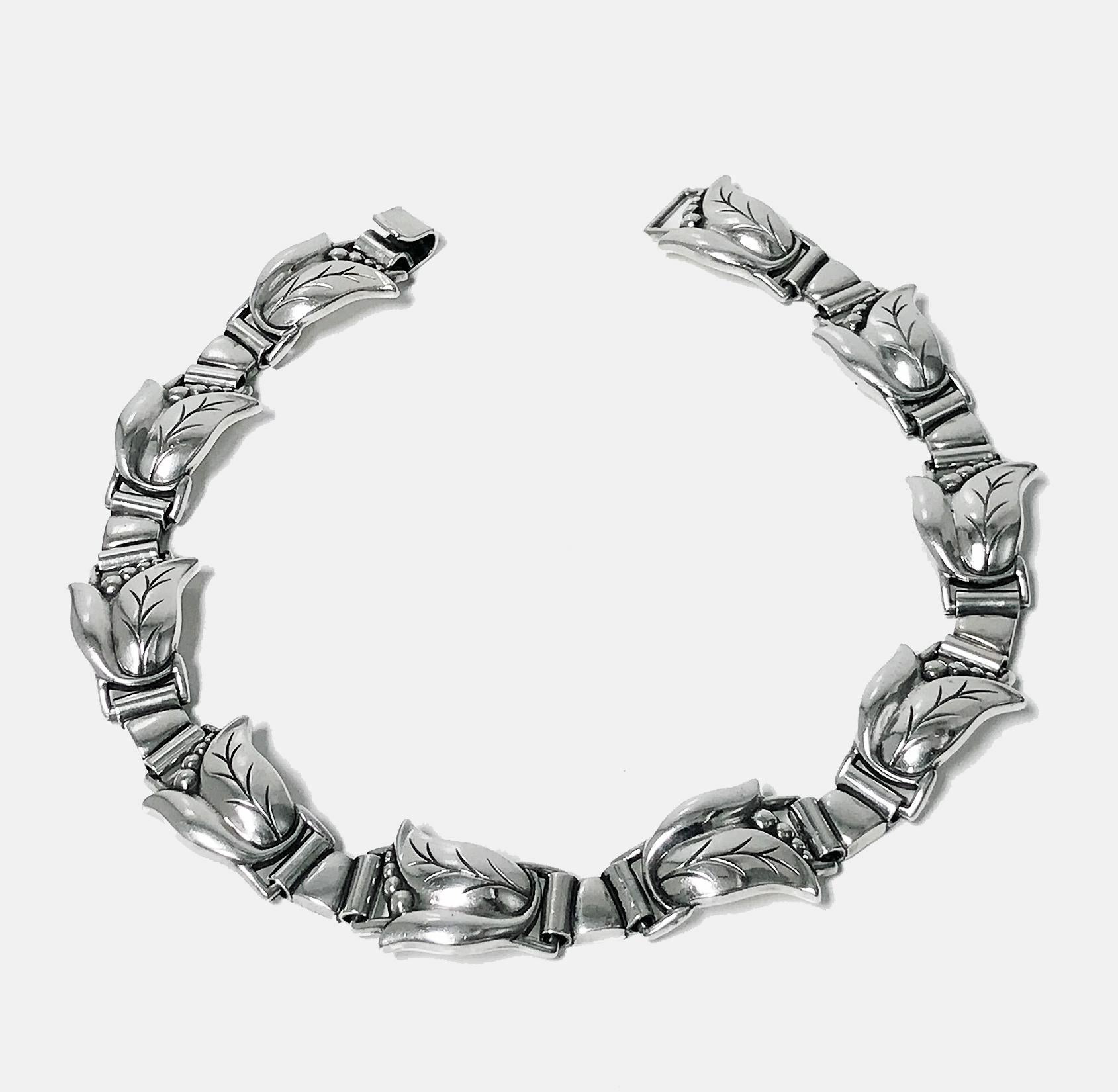 Georg Jensen Sterling convertible Necklace and Bracelet, C.1940. The Necklace and Bracelet, fleur danoise design, convertible to longer necklace, with hinged stylised tulip bud petal links, Georg Jensen Sterling USA marks to reverse and design