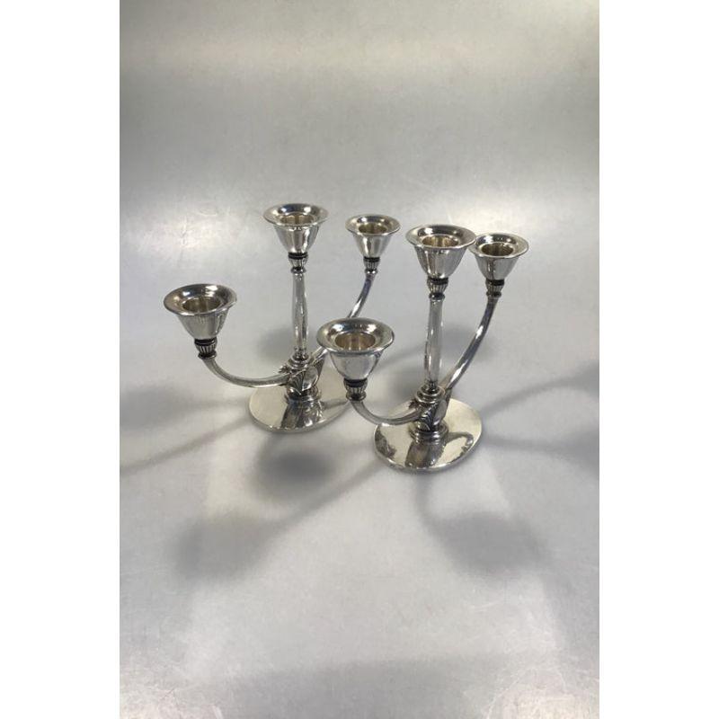 Georg Jensen sterling silver 3-armed candlesticks No 673B (2) 

Measures H 16 cm (6 1/3 in) Weight 1073 gr / 37.85 oz.