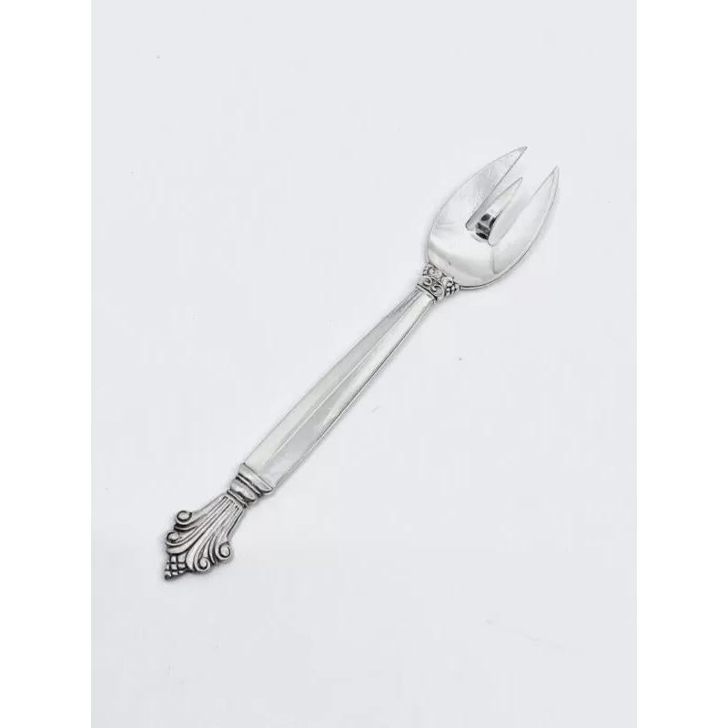 A Georg Jensen sterling silver cocktail fork, item  #328 in the Acanthus pattern, design #180 by Johan Rode from 1917.

Additional Information:
Material: Sterling Silver
Style: Art Nouveau
Hallmarks: With Georg Jensen hallmark, made in