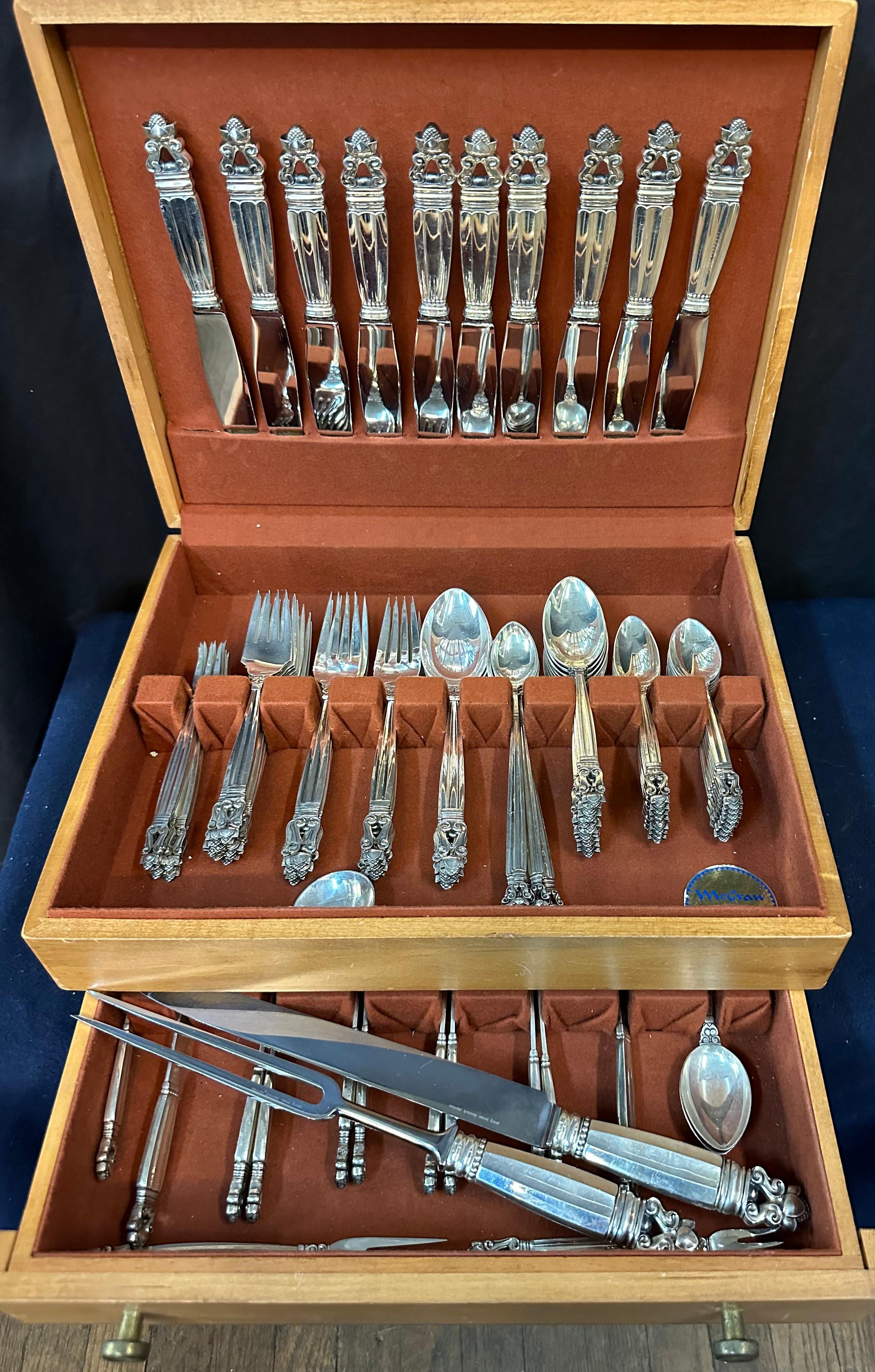 This stylish sterling silver flatware service for ten is designed in the Acorn pattern. It was produced by Georg Jensen & is circa 1917.
The flatware set of ninety three pieces weighs 118.5 ounces. It is assembled in a wood box & includes:
10 dinner