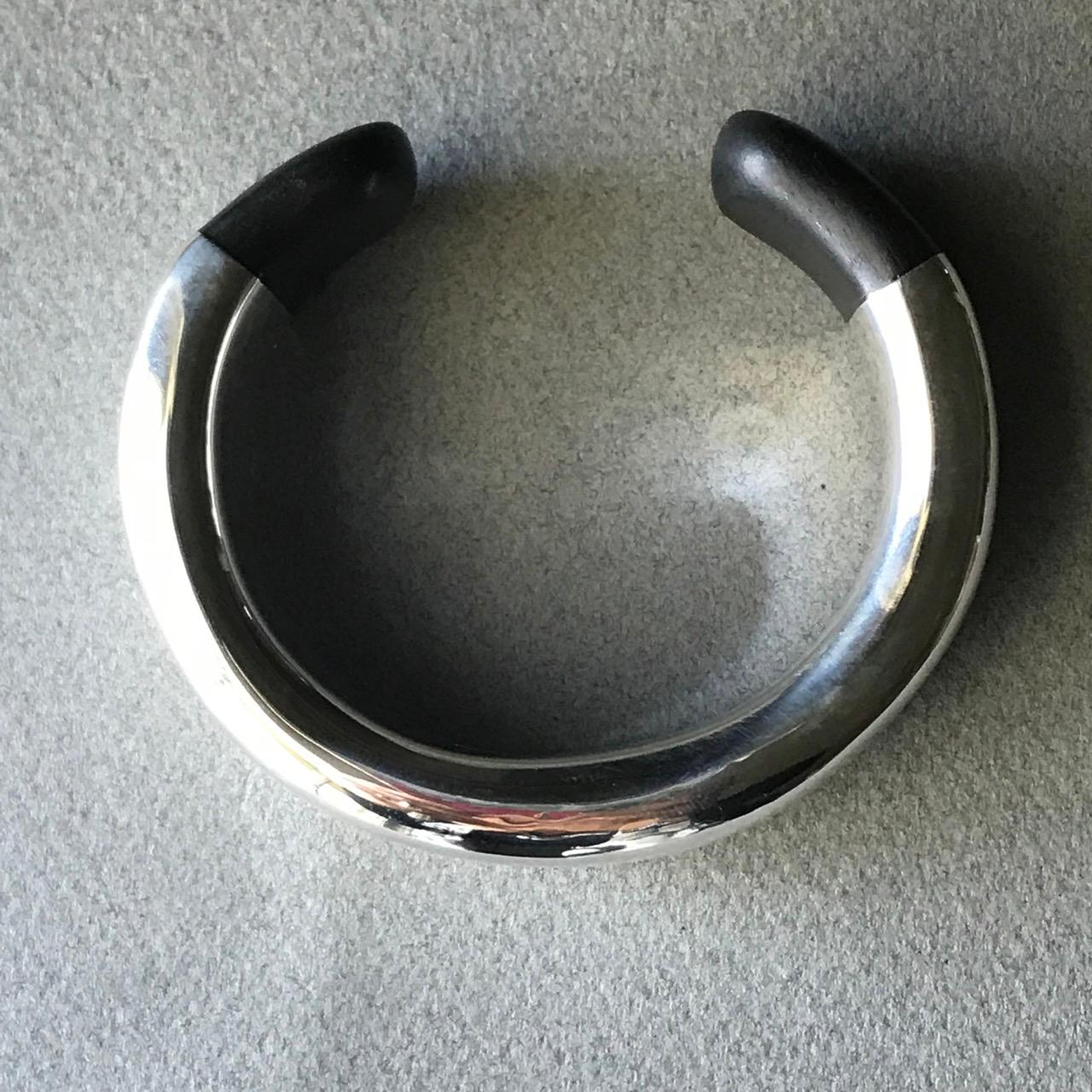 Georg Jensen Sterling Silver and Ebony Wood Bold Cuff Bracelet by Ove Wendt
Complimentary gift box included with purchase.

Georg Jensen Sterling Silver and Ebony Wood Bold Cuff Bracelet. This a rare design by Ove Wendt from 1970s hand-fabricated of