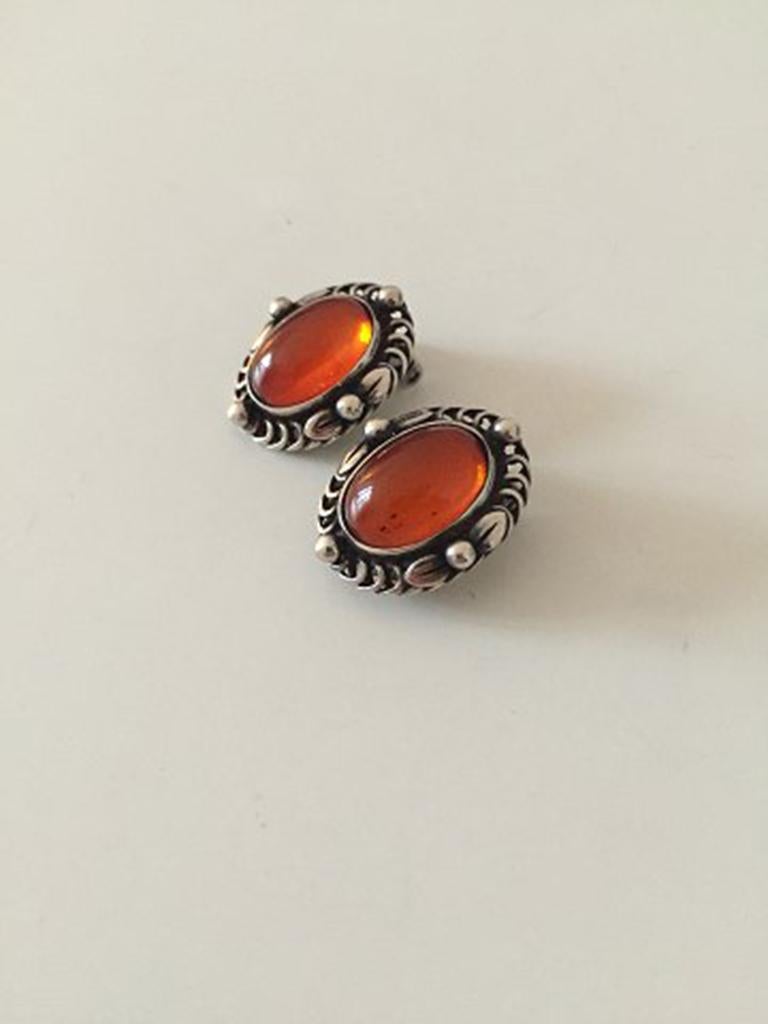 Georg Jensen Sterling Silver Annual Earclips with amber from 1995. Measures 2.3 cm / 0 29/32 in. Weighs 14 g / 0.50 oz.