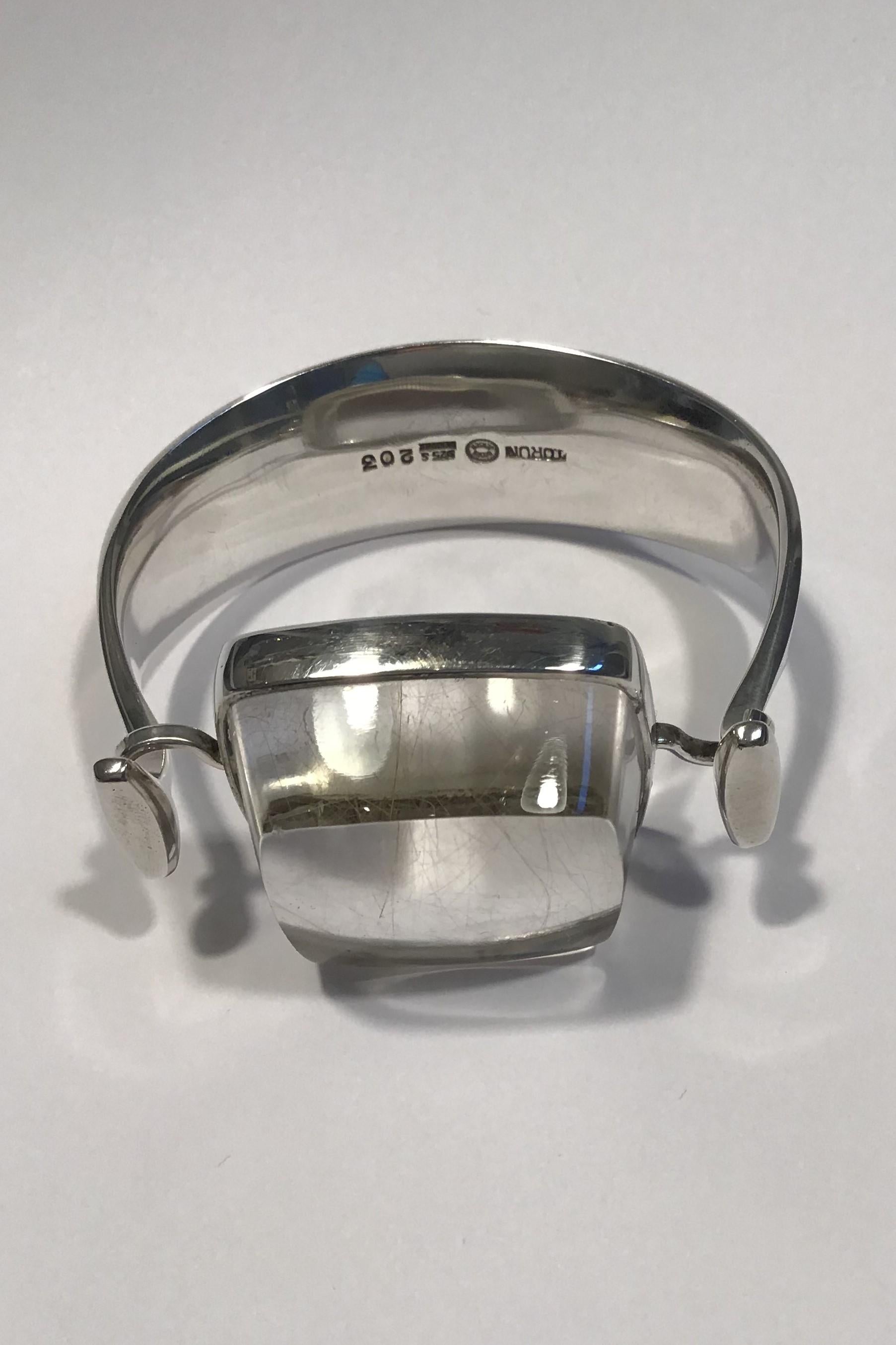 Georg Jensen Sterling Silver Arm Ring No 203 with Rutile Quartz Torun

Arm Ring dia 5.9 cm(2.32 in) 
Quartz 3.5 cm x 3.5 cm x 1.7 cm (1.37 in x 1.37 in x 0.67 in) 
Combined weight 83.1 gr/2.93 oz