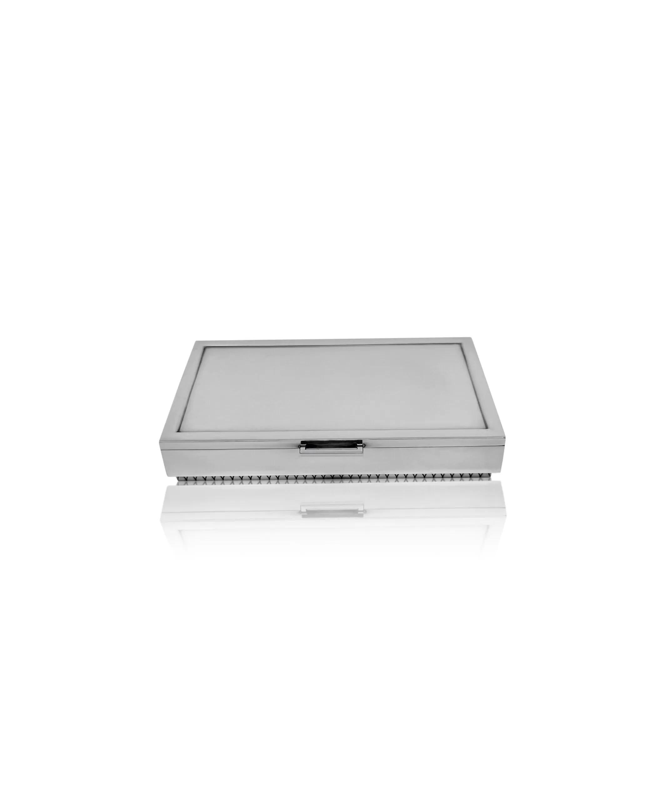 A vintage Georg Jensen Art Deco box crafted from early sterling silver, featuring design #825 by Sigvard Bernadotte dating back to 1938. The robust rectangular box is expertly hand-chased along its edges with an intricate art deco pattern. The lid
