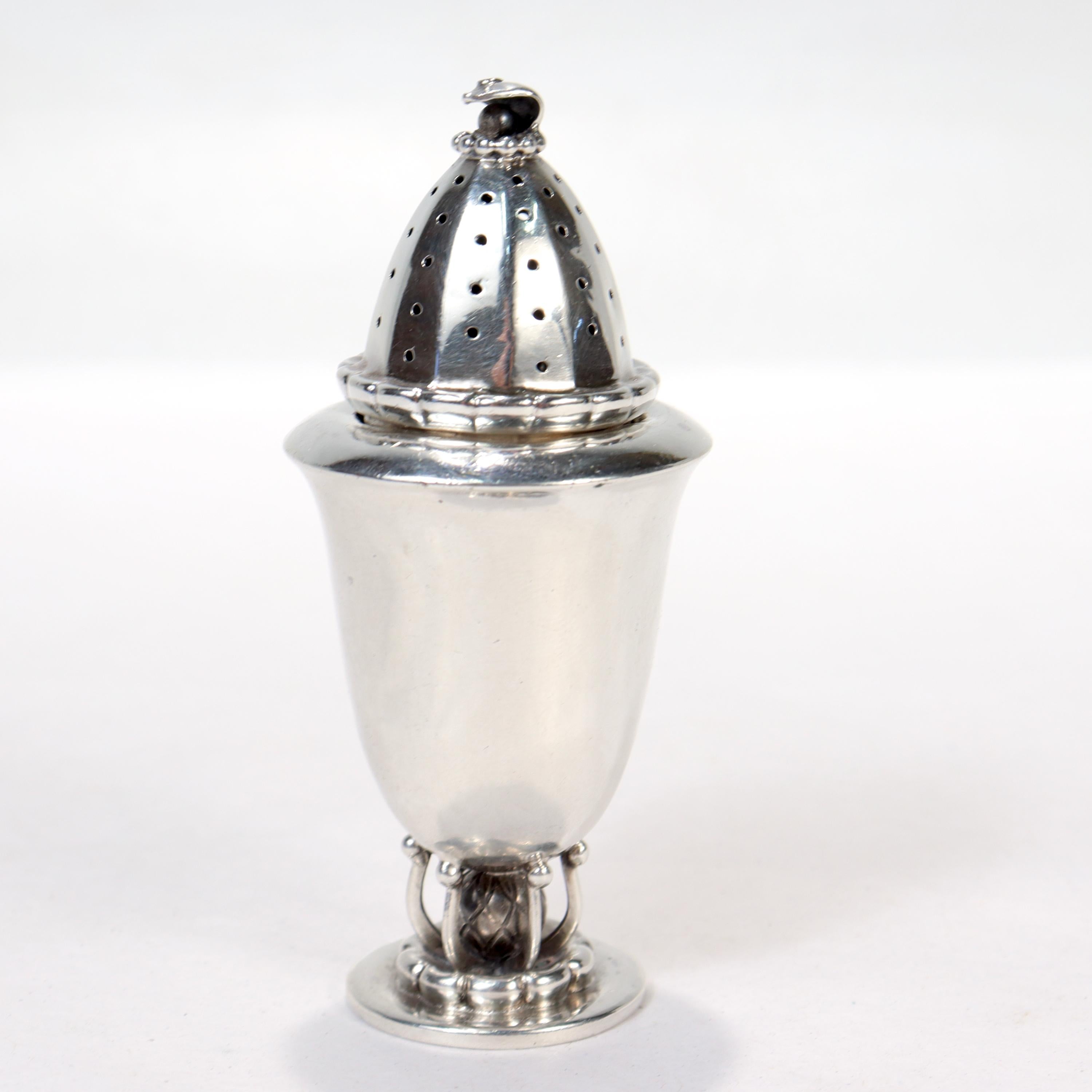 A fine sterling silver pepper shaker or caster.

By Georg Jensen.

Model no. 236

Simply great Art Deco design!

Date:
1925-1932

Overall Condition:
It is in overall good, as-pictured, used estate condition.

Condition Details:
The finial to the
