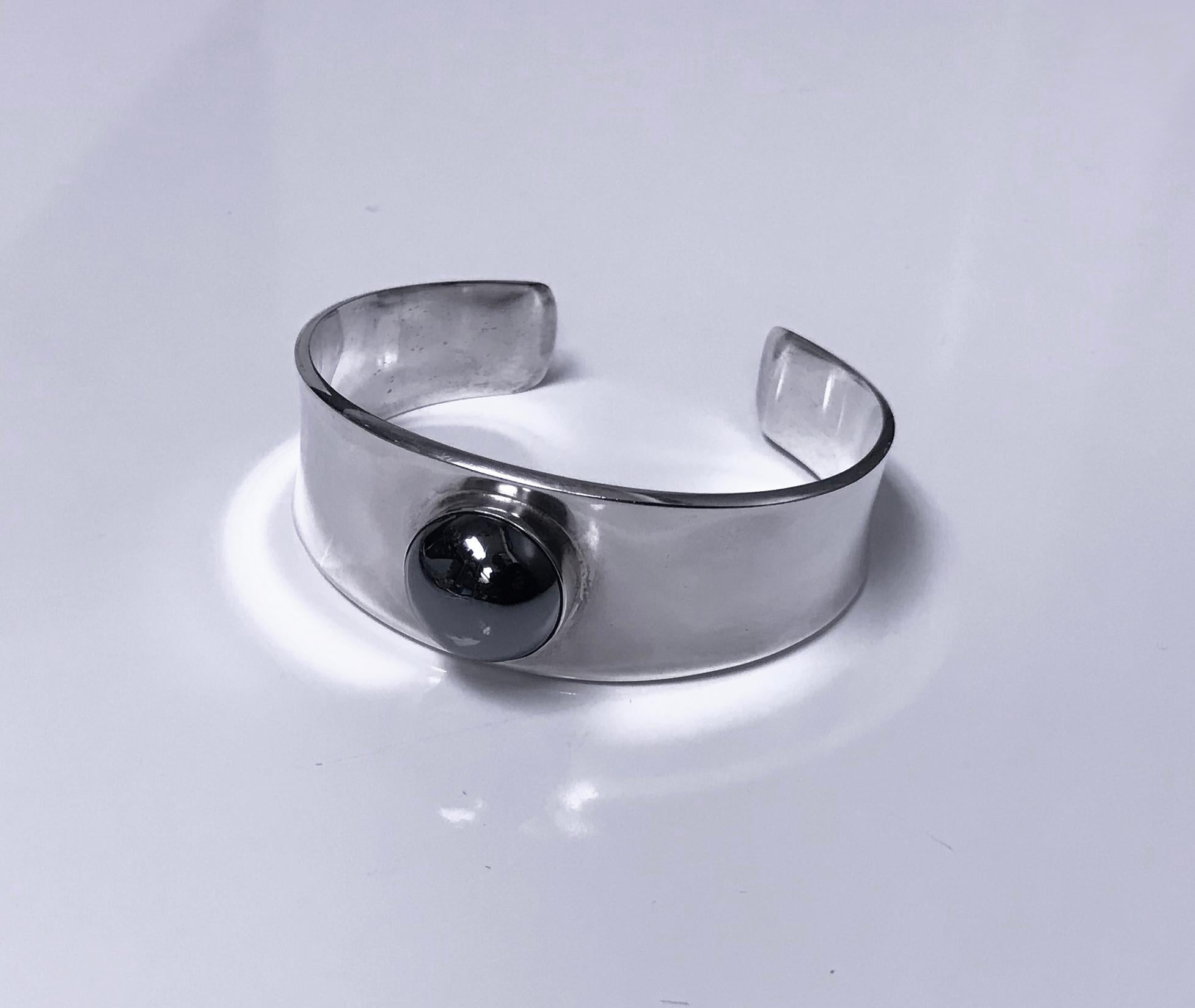 Georg Jensen Sterling Silver Bangle Bracelet #188 designed by Paul Hansen. Plain very slightly tapered bezel set with hematite. Stamped post 1945 Georg Jensen marks 925 Sterling Denmark Design 188. Diameter measures 6.5 cm 2.6 inches. Will fit wrist