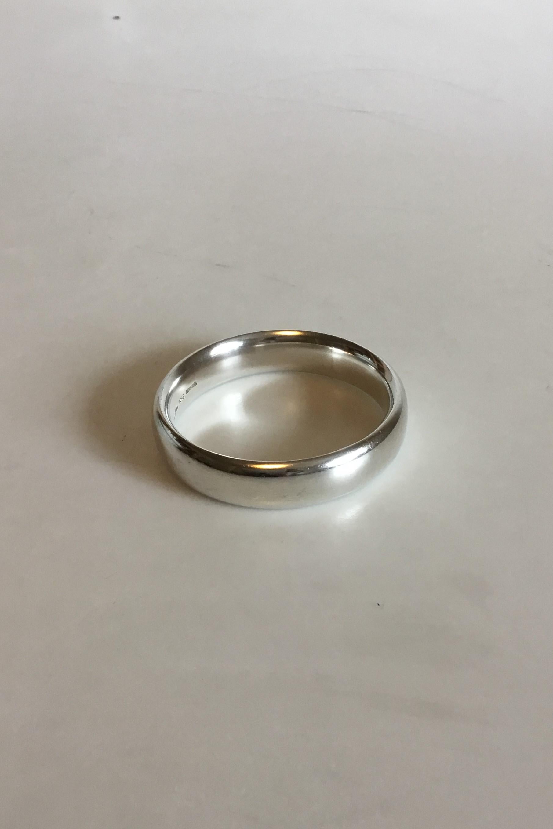 Georg Jensen Sterling Silver Bangle designed by Hans Hansen. 

Measures 7.4 cm / 2 29/32 in. dia. x 1.6 cm / 0 5/8 in. wide. 
Weight 70 g / 2.45 oz.