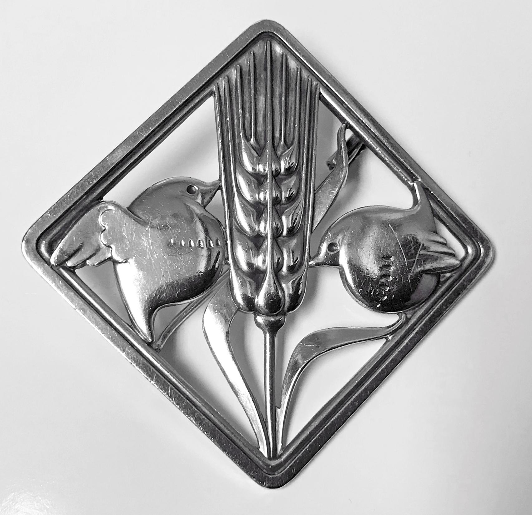 Georg Jensen Sterling Silver Birds Brooch, 1933-44. Fully hallmarked Georg Jensen GJ in box , 925 Sterling Denmark and design number 250. Designed by Arno Malinowski for Georg Jensen. The brooch of quadrilateral shape depicting two birds with branch