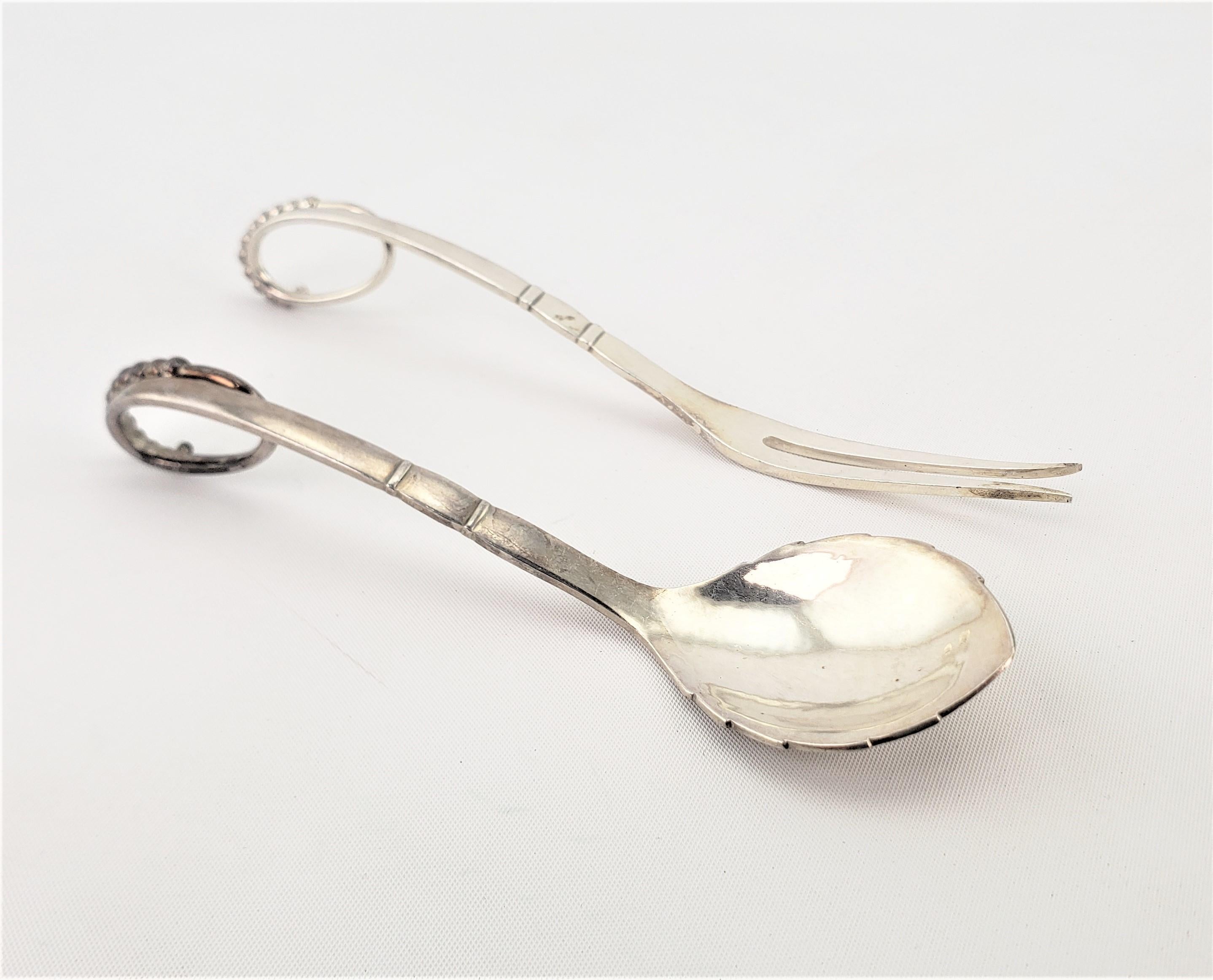 This sterling silver fork and knife set were made by the renowned Georg Jensen of Denmark in his Blossom pattern in a naturalistic or organic style. Both pieces are clearly hallmarked, and bear the maker's mark for Jensen dating to approximately