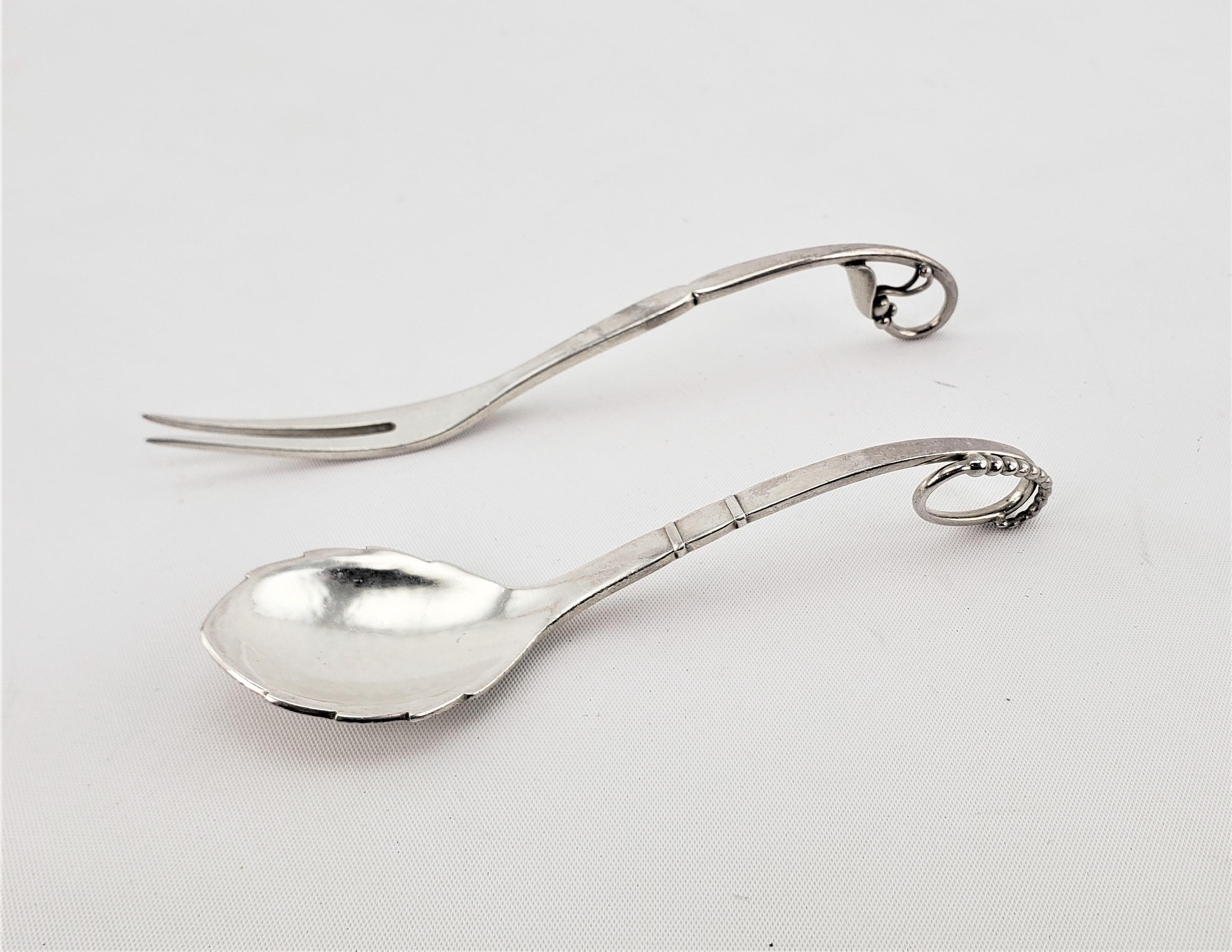 This sterling silver fork and knife set were made by the renowned Georg Jensen of Denmark in his Blossom pattern in a naturalistic or organic style. Both pieces are clearly hallmarked, and bear the maker's mark for Jensen G1 dating to approximately