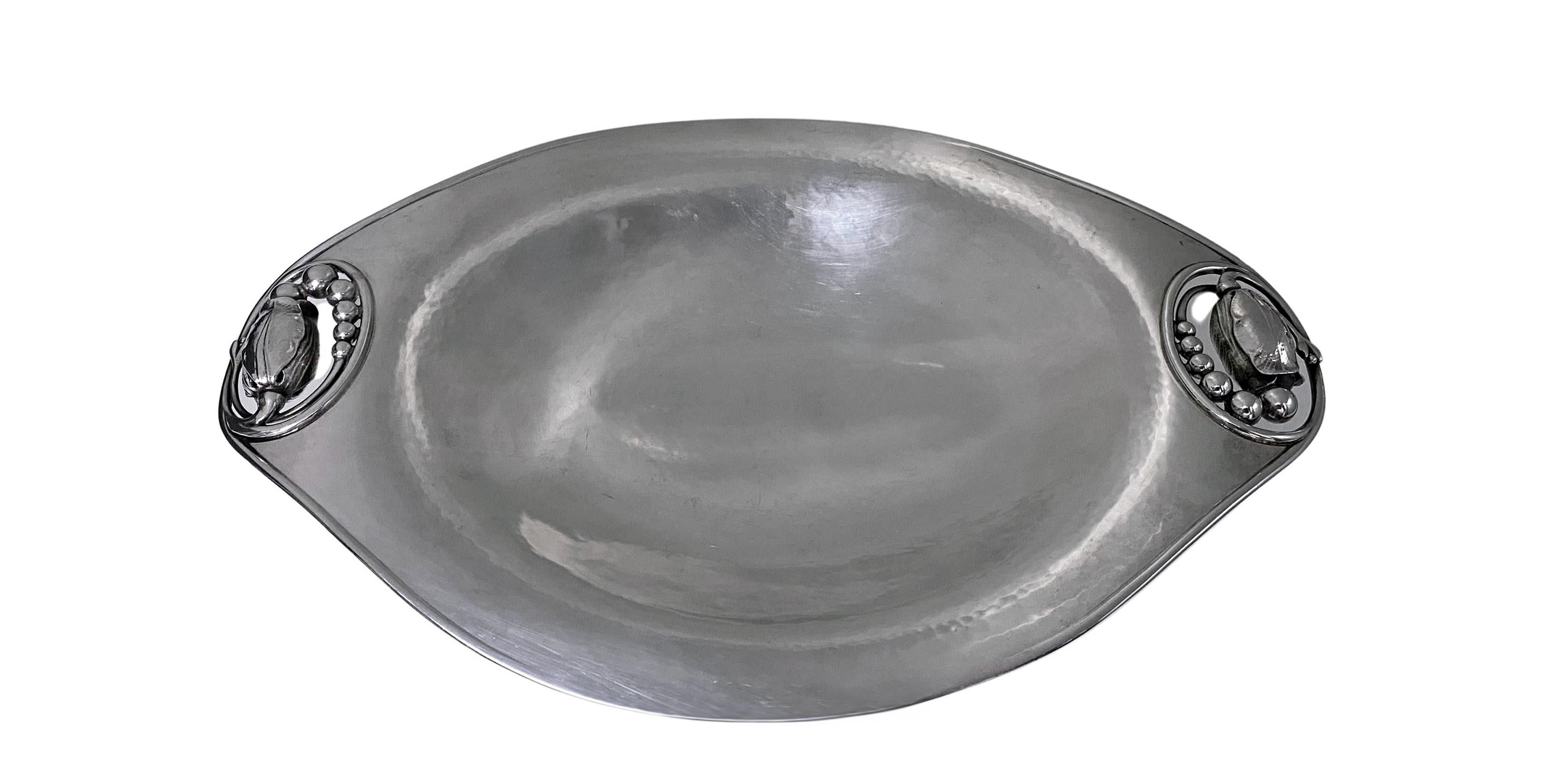 Georg Jensen sterling silver blossom or magnolia oval footed dish tray Denmark post 1945, design #2A. Lightly hand hammered finish, slightly undulating sides, handles reverse open blossom buds, plain pedestal base Measures: 12.00 (length) x 7.75 x