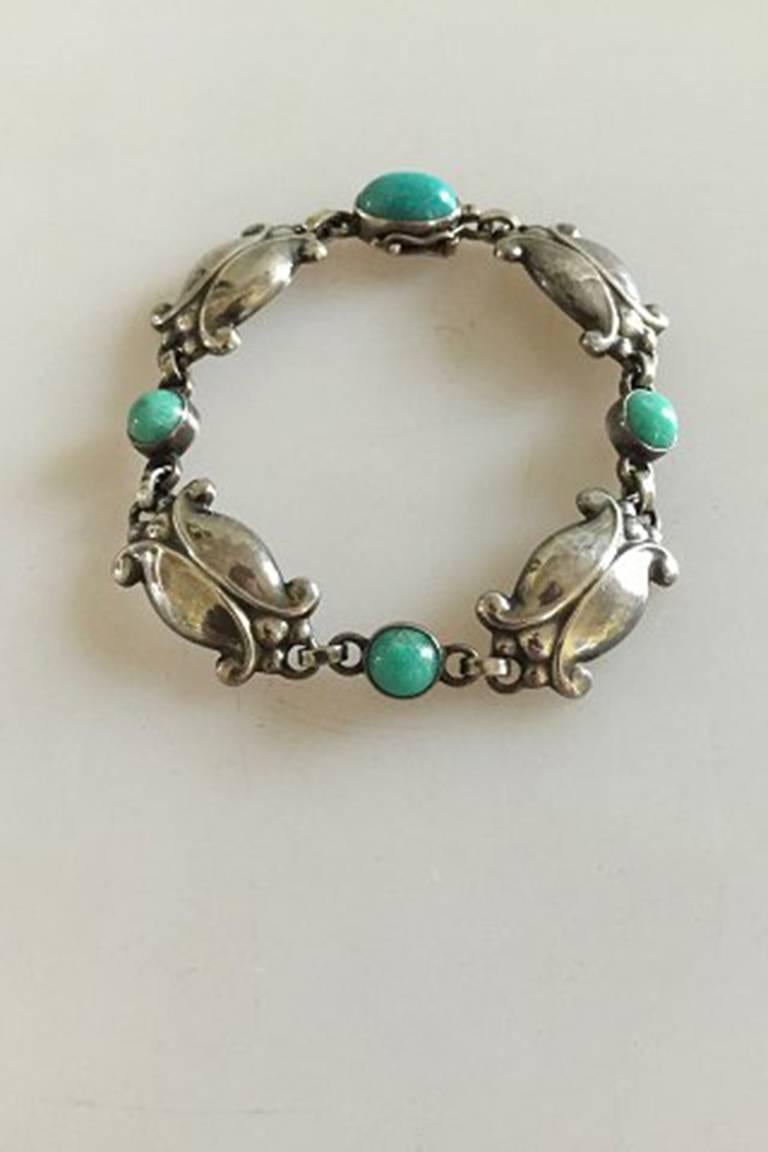 Georg Jensen Sterling Silver Bracelet No 11 with Green Agates. From after 1945.

Measures 18 cm x 1.5 cm wide / 7 3/32 in. x 0 19/32 in.