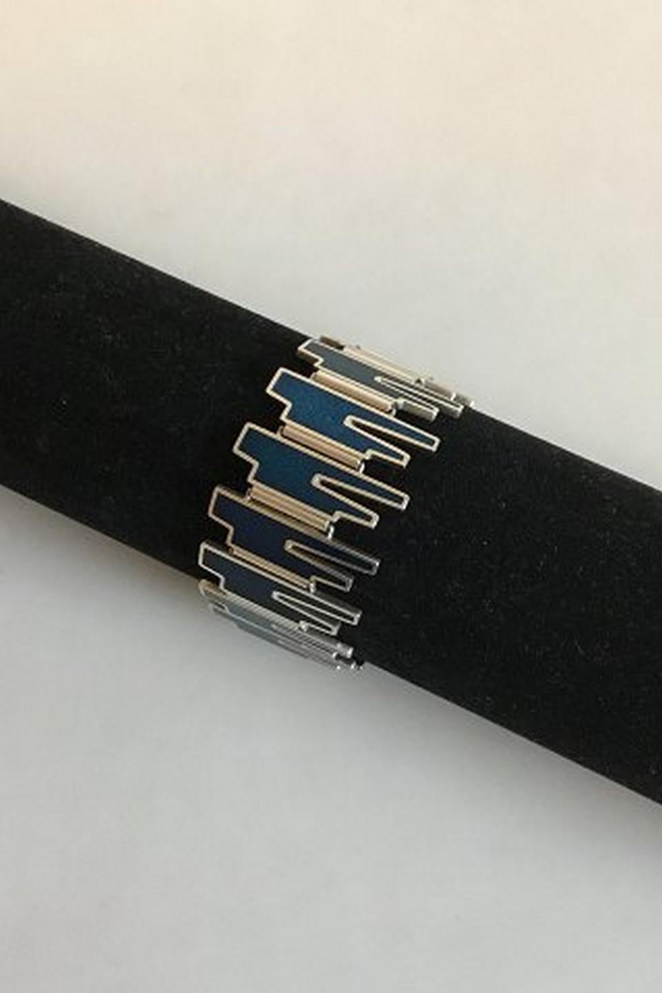Georg Jensen Sterling Silver Bracelet with blue enamel No 120. 

Designed by Bente Bonne. 
Measures 18 cm / 7 3/32 in. x 2.8 cm / 1 7/64 in. 
Weighs 66 g / 2.3 oz.