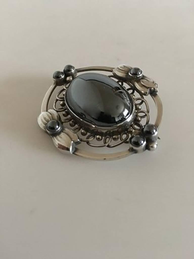 Georg Jensen Sterling Silver Brooch #91 with Hematite Stones. Measures 5 x 4 cm (1 31/32 in. x 1 37/64 in.). Weighs 23 grams (0.90 oz). From after 1945.