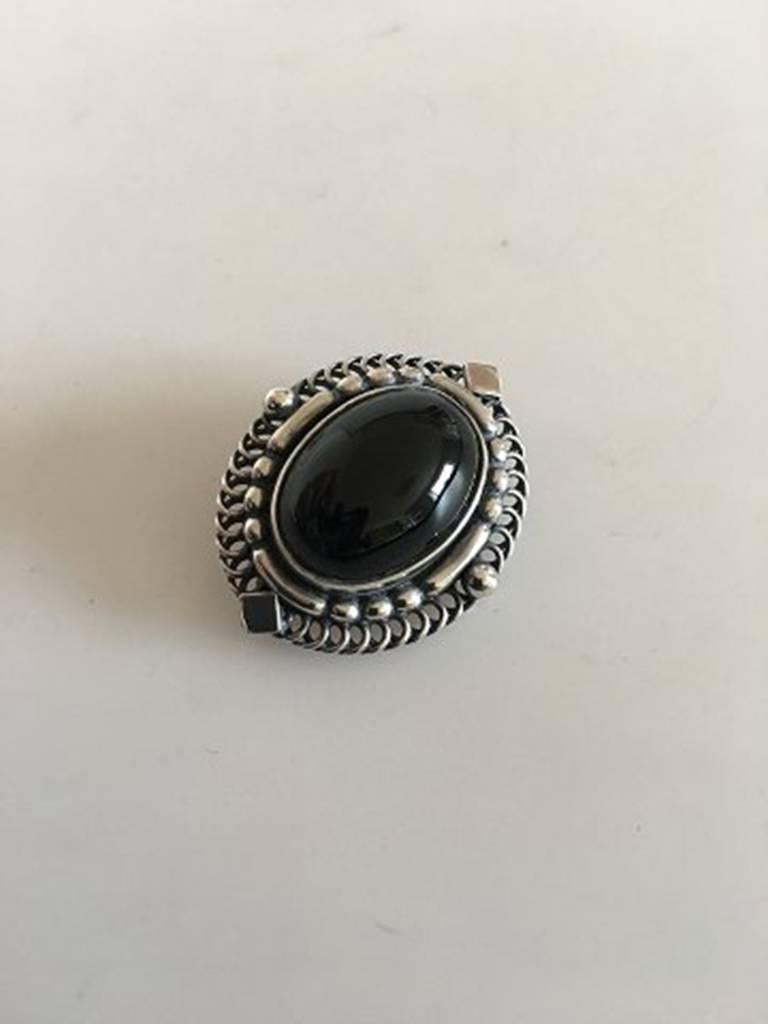 Georg Jensen Sterling Silver Brooch with Black Onyx Stone No 419. Measures 3 cm / 1 3/16 in. x 2.5 cm / 0 63/64 in. Weighs 11.5 g / 0.41 oz. From after 1945