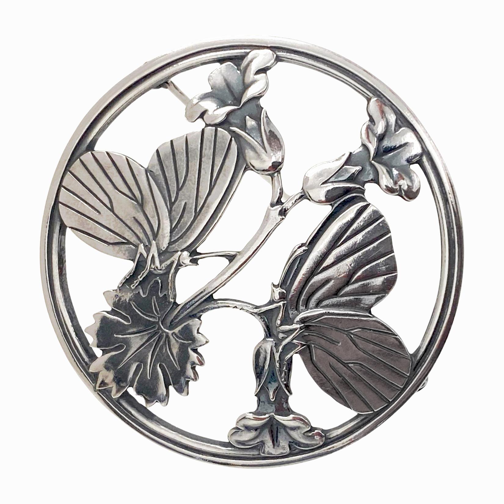 Georg Jensen Sterling Silver Butterfly and stylized Flowers Brooch C.1940. Large Brooch fully hallmarked GJ in box, Sterling Denmark and design number 283, C.1940’s. Designed by Arno Malinowski for Georg Jensen. The brooch of circular shape with