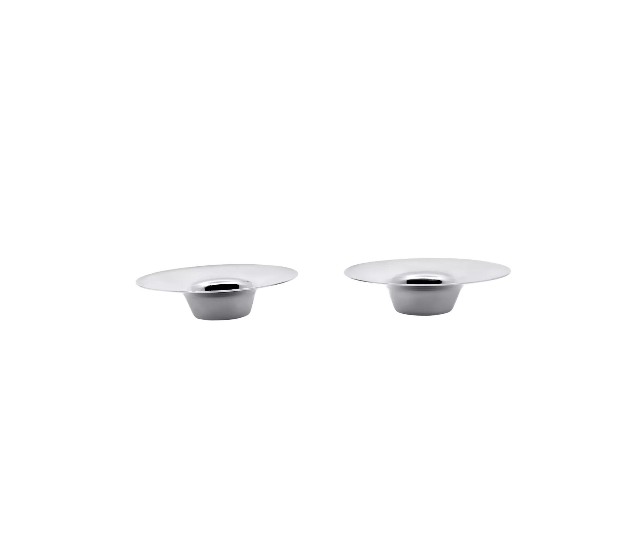 A pair of small modern sterling silver candlesticks, designed by Nanna Ditzel under #1112. They feature a round, circular base with a turned-out outer rim resembling an upside-down hat.

- Dimensions: Each measures 2 7/8 inches (7 cm) in diameter x