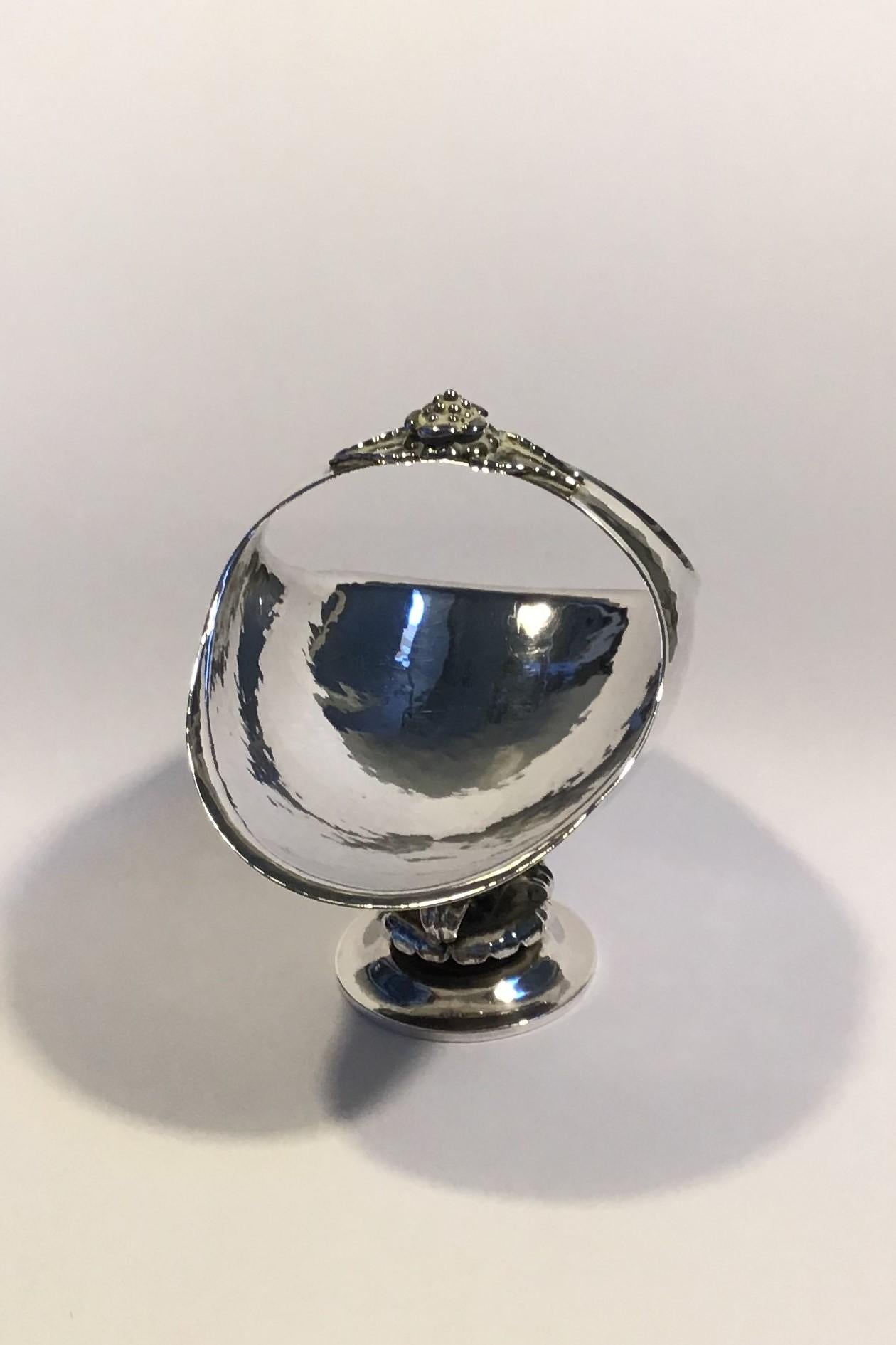 Georg Jensen sterling silver candy basket no 238 (1915-1927).

Measures: H 10 cm (4 in) 10.5 cm x 7.5 cm (4 9/64 in x 2 61/64 in)
Weight 113.7 gr/4 oz.