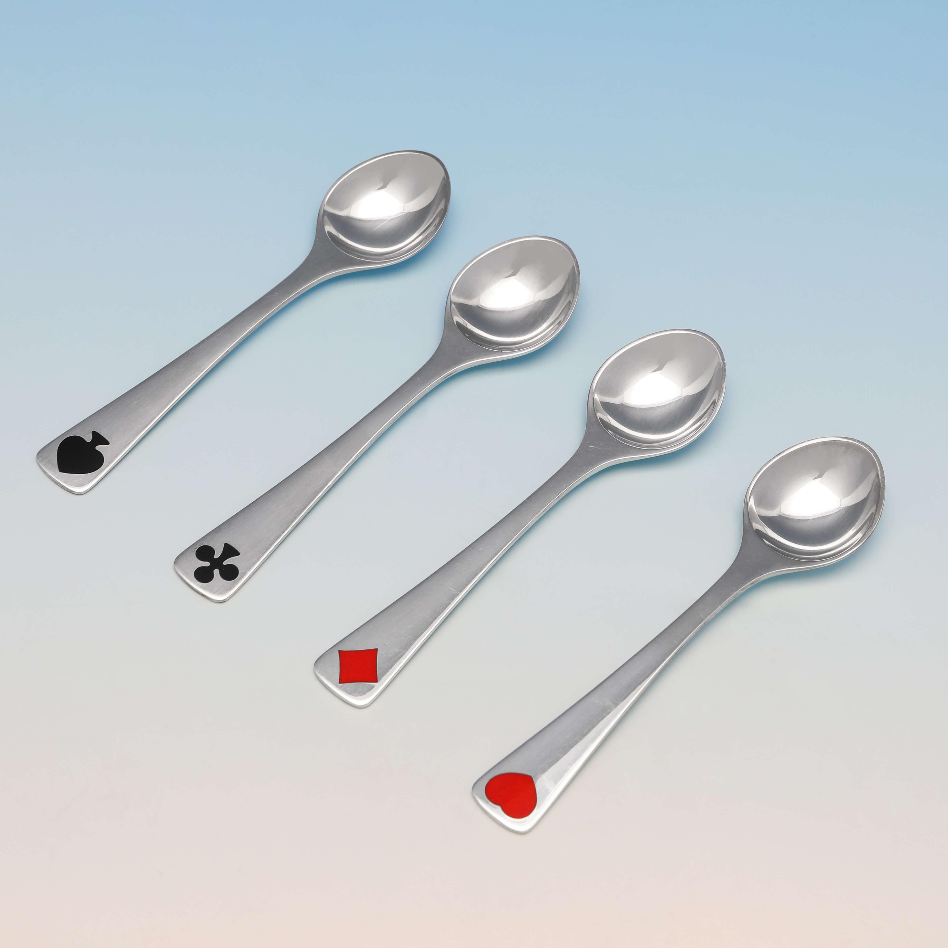 Made by Georg Jensen and carrying the post 1945 mark, this stylish set of sterling silver tea spoons, were designed by Henning Koppel, and are enameled with the 4 card suits, and presented in their original box. Each teaspoon measures 4