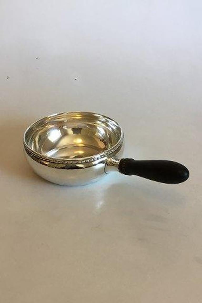 Georg Jensen sterling silver casserole bowl with handle no 55B. (1930-1945) 

Measures 28.5 cm / 11 7/32 in. Weighs 438.3 gr g / 15.46 oz.