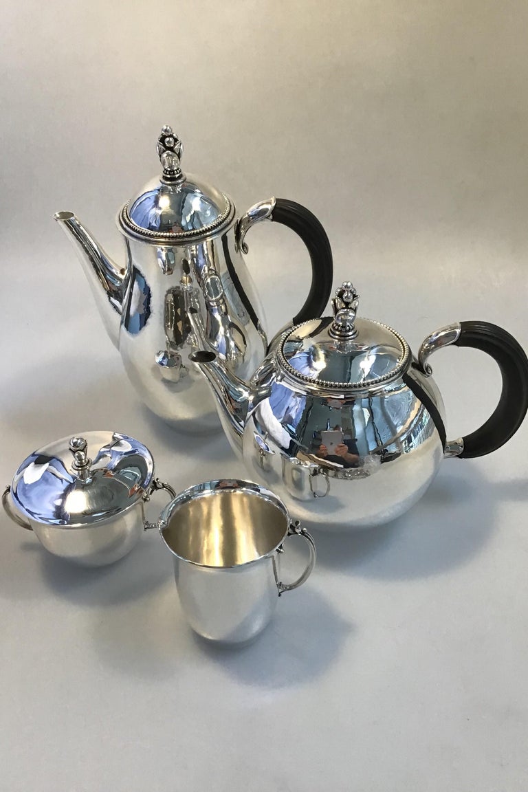 Georg Jensen sterling silver coffee pot, tea pot creamer and sugar bowl No 456

Measures: Coffee pot 456A H 24 cm (9.44 in), weight 620 gr 21.88 oz
Tea pot 456B H 18 cm (7.08 in), weight 594 gr20.97 oz
Creamer 456B H 8 cm (3.14 in), weight 153
