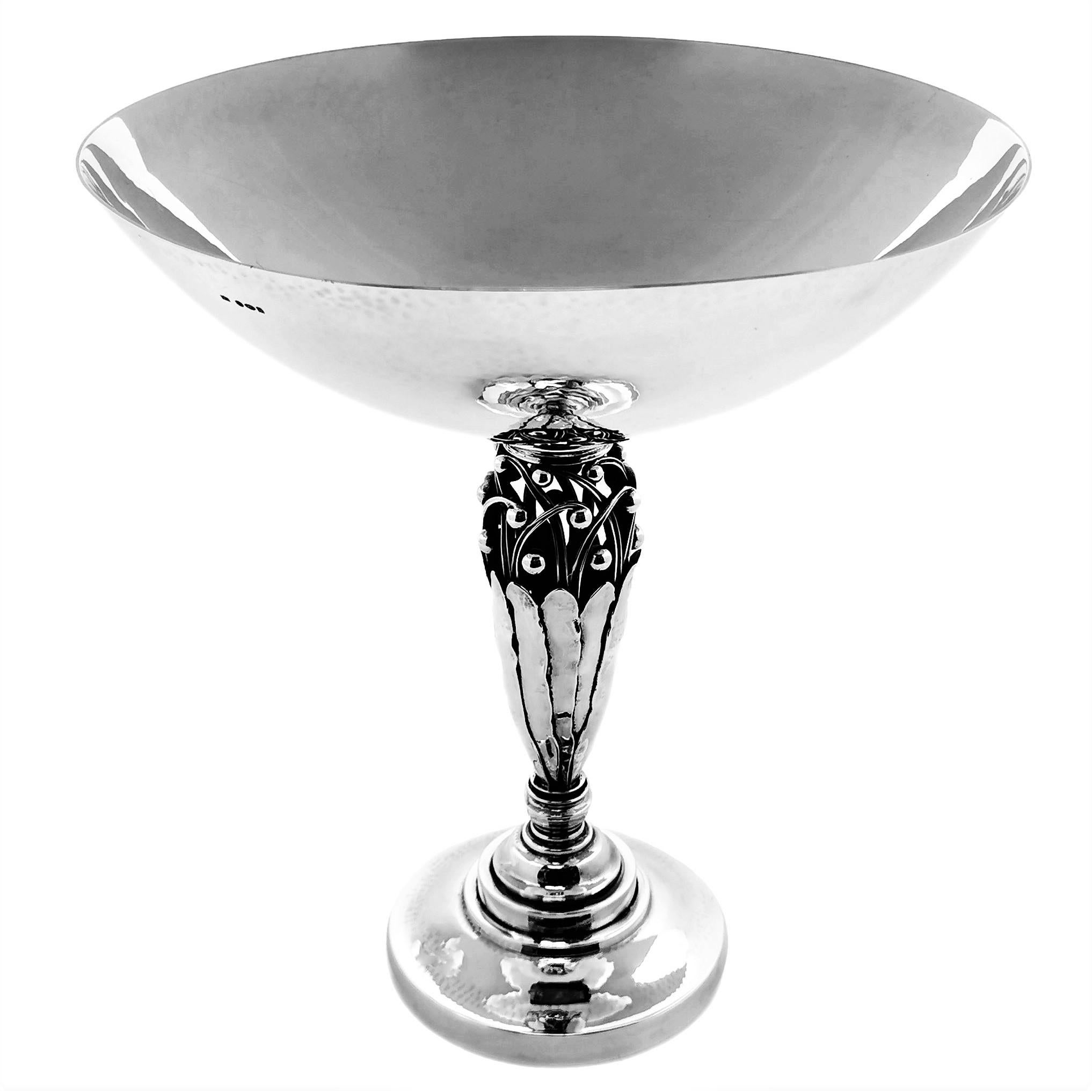 A beautiful Georg Jensen solid Silver Compote with a wide hammered silver bowl on a stylised leaf and floral column on a spread foot. The Comport was Design by Johan Rohde and made by Georg Jensen and is design number 574. 

Made in Copenhagen