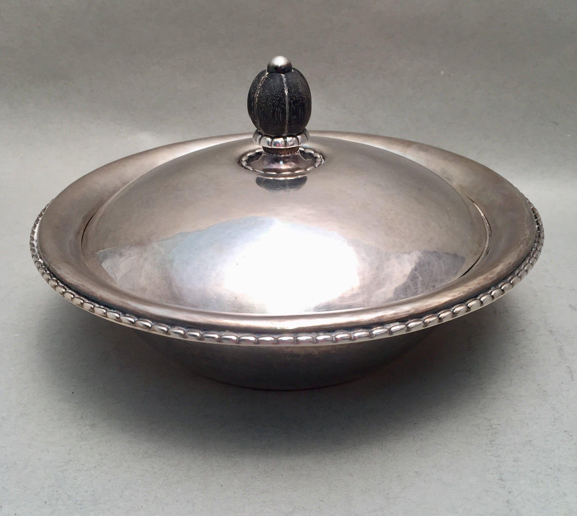 Georg Jensen Danish divided vegetable serving bowl in the blossom pattern. Blossom buds on two sides across from each other. Measuring 12 inches long, 9 inches wide, and 2 3/4 inches tall. Weighing 36.9 troy ounces. Bearing hallmarks as shown.