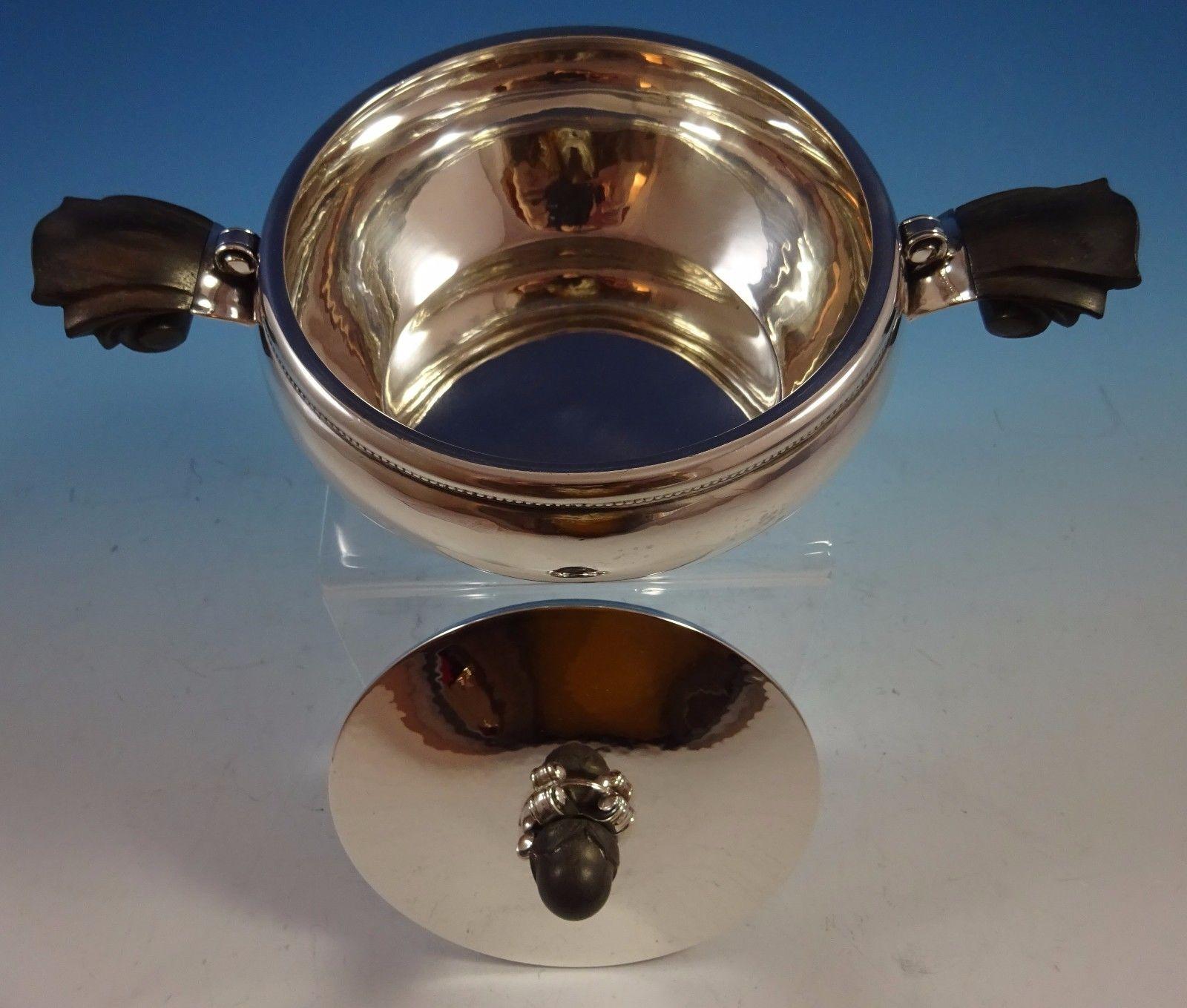 Georg Jensen
Very fine Georg Jensen sterling silver entree dish / vegetable dish with cover featuring carved rosewood handles and finial. The piece has a GI mark for 1910-1930, and it's marked with #613. Also has English import mark for 1930. The