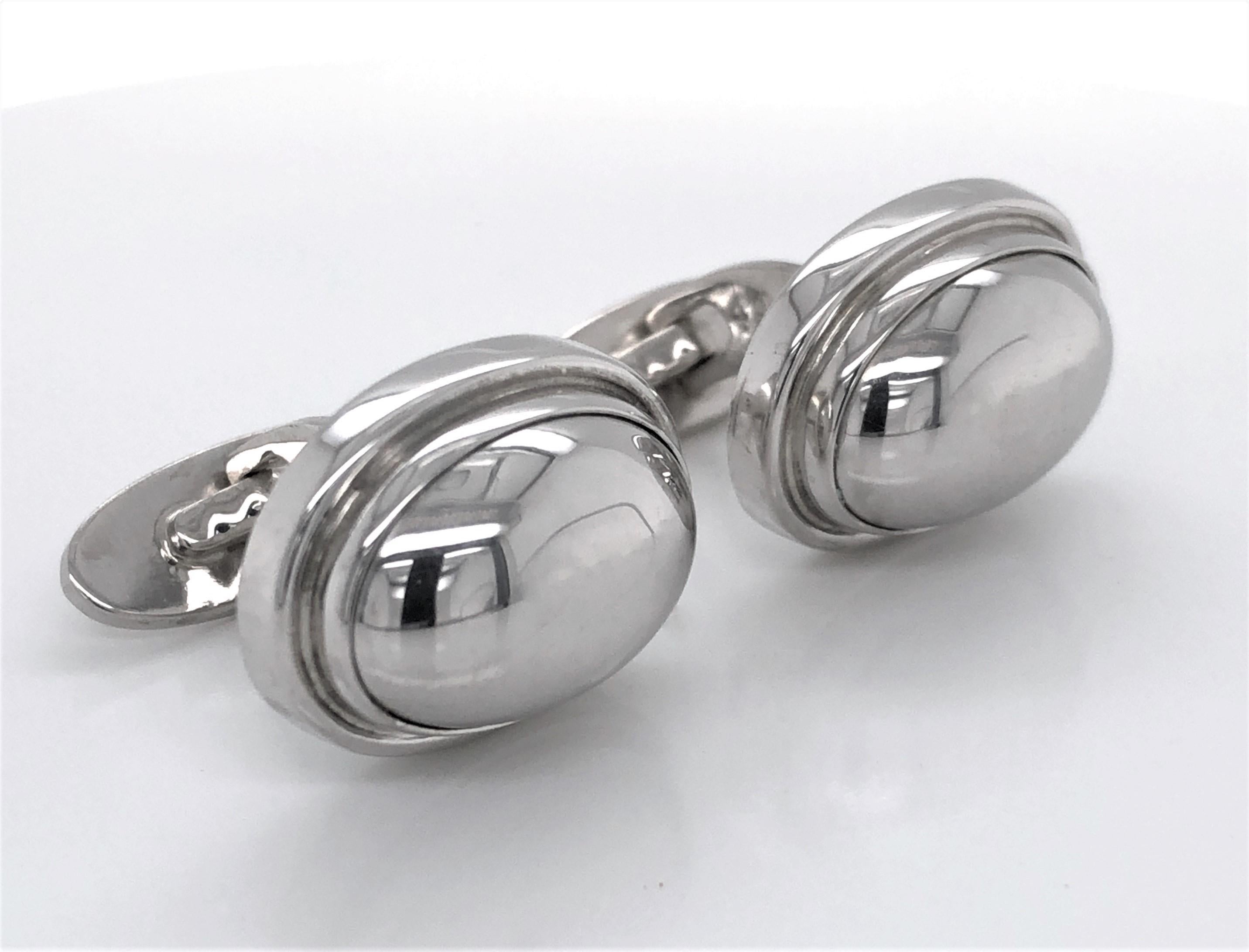Classic and timeless by Danish silver maker Georg Jensen. These oval domed sterling silver cuff links #44B with silver bezel were designed by Harald Nielsen and display
pleasing clean lines found in Scandinavian craftsmanship. Circa 1950 - 1999,