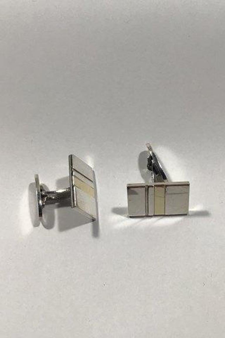 Georg Jensen sterling silver cufflinks no 152 with 18K gold lene munthe 

Measures 1.2 cm x 2.1 cm(0 15/32 in x 0 53/64 in) combined weight 16.3 gr/0.57 oz.
 