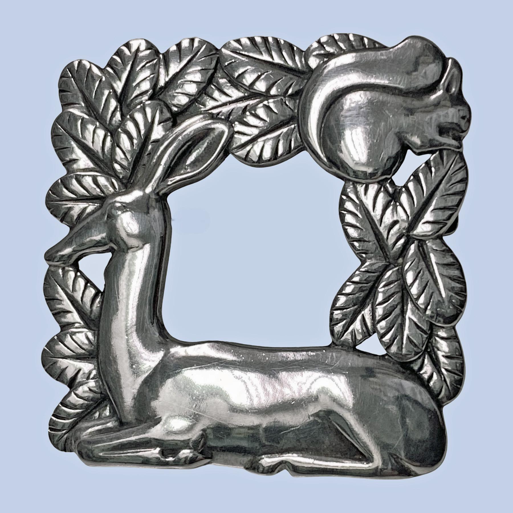 Georg Jensen Sterling Silver Deer and Squirrel Brooch #318 Vintage Sterling Silver, designed by Arno Malinowski. Intricately detailed, open-squared brooch featuring a deer resting with squirrel in foliage. Measures: 1.5 x 1.5 inches. Item Weight: