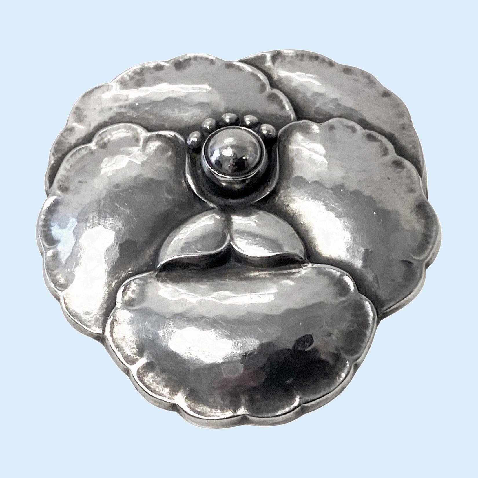 Georg Jensen Sterling Silver Flower Brooch # 113, Denmark1933-44. Lightly hammered three-dimensional petal brooch, pin with safety catch at reverse. Originally designed by Georg Jensen. Full Georg Jensen marks GJ in box for 1933-44 and number 113.