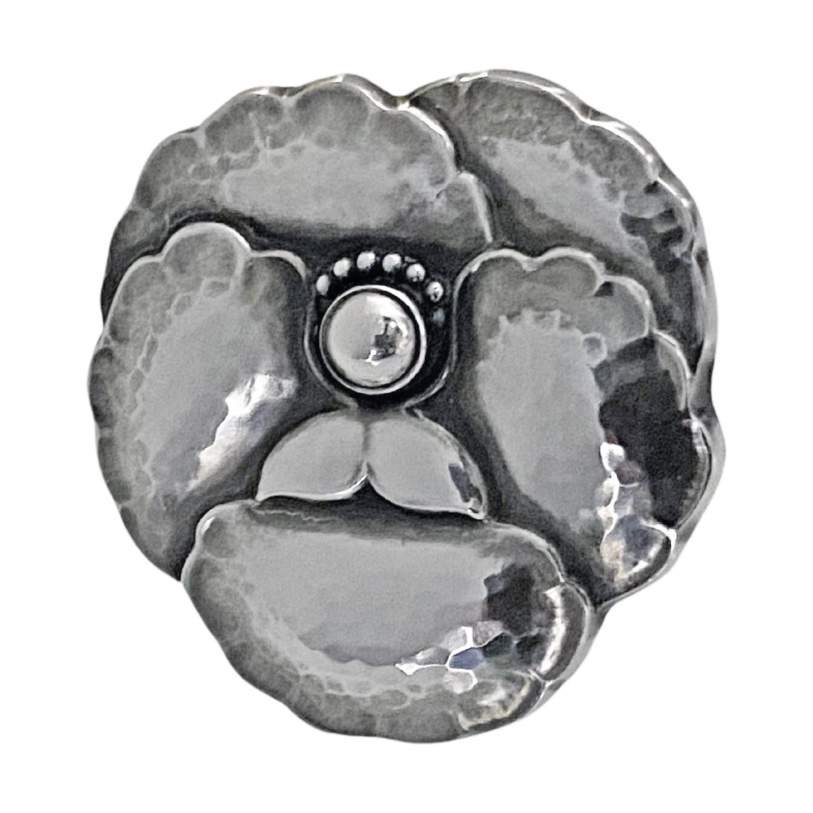 Georg Jensen Sterling Silver Flower Brooch # 113. Lightly hammered three-dimensional petal brooch, pin with safety catch at reverse. Originally designed by Georg Jensen. Full Georg Jensen marks and number 113. Measures: 1.60 x 1.60 inches. Item