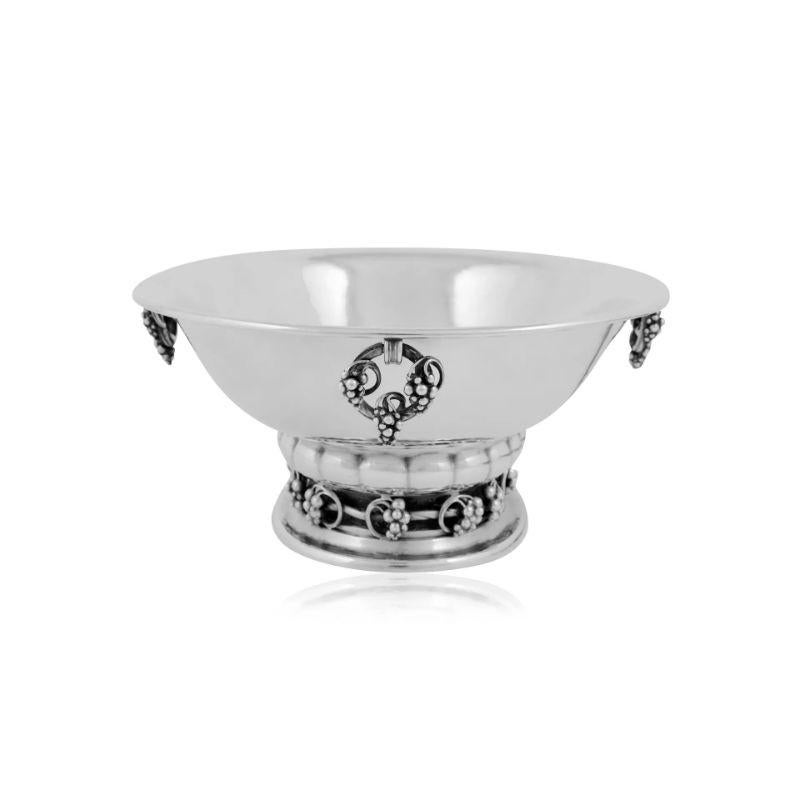 A medium Georg Jensen sterling silver Grape oval jardinière centerpiece bowl, design #296B by Georg Jensen. A hand hammered large oval bowl that rests on an oval base surrounded by vines and grapes. There are four wreath-like hinged grape rings that