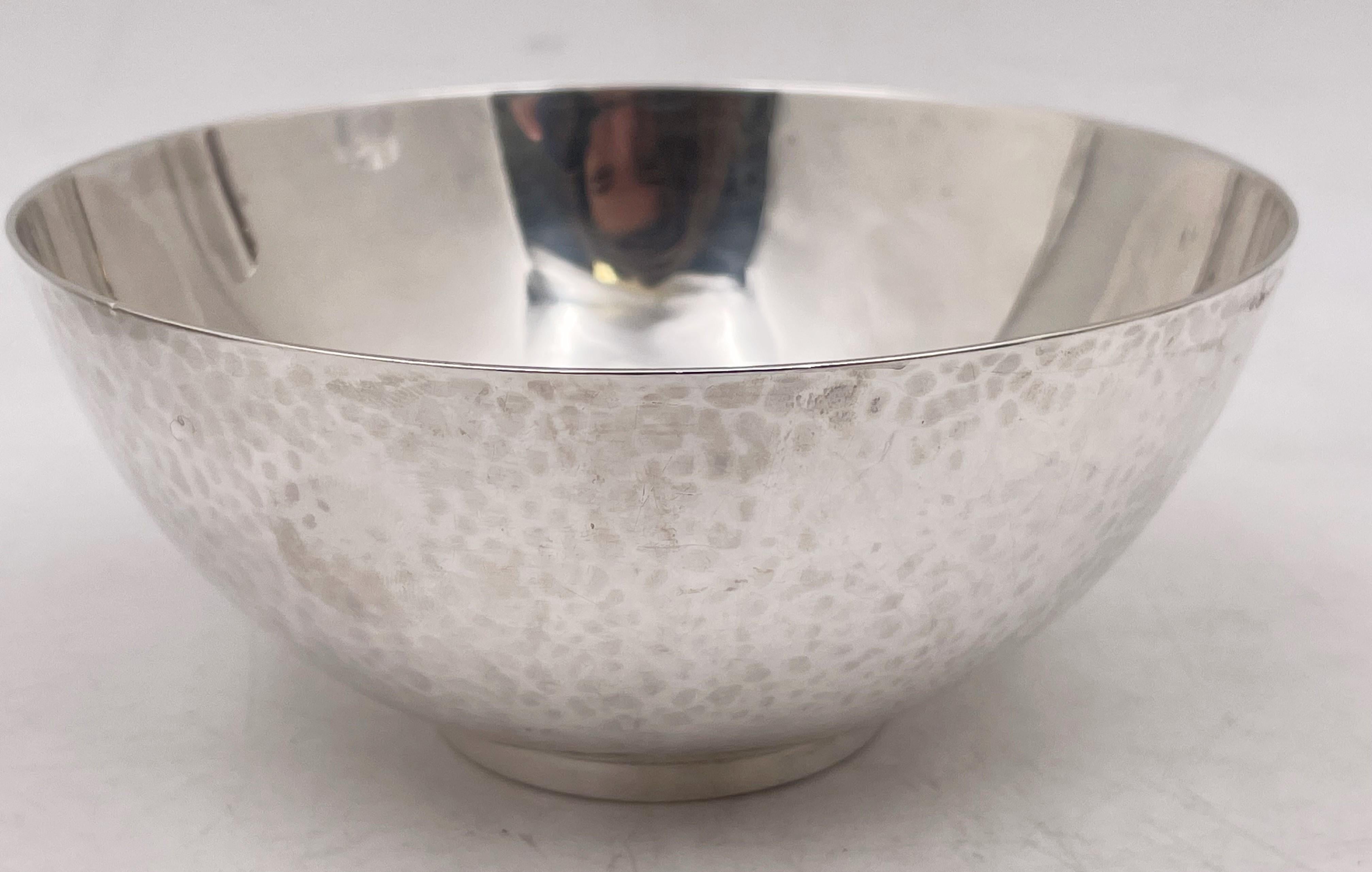 Georg Jensen hand-hammered sterling silver bowl in pattern number 580, made between 1925 and 1932, measuring 4 7/8’’ diameter by 2 1/8’’ in height, weighing 6.9 troy ounces, and bearing hallmarks and a monogram as shown. 

Danish silversmith Georg