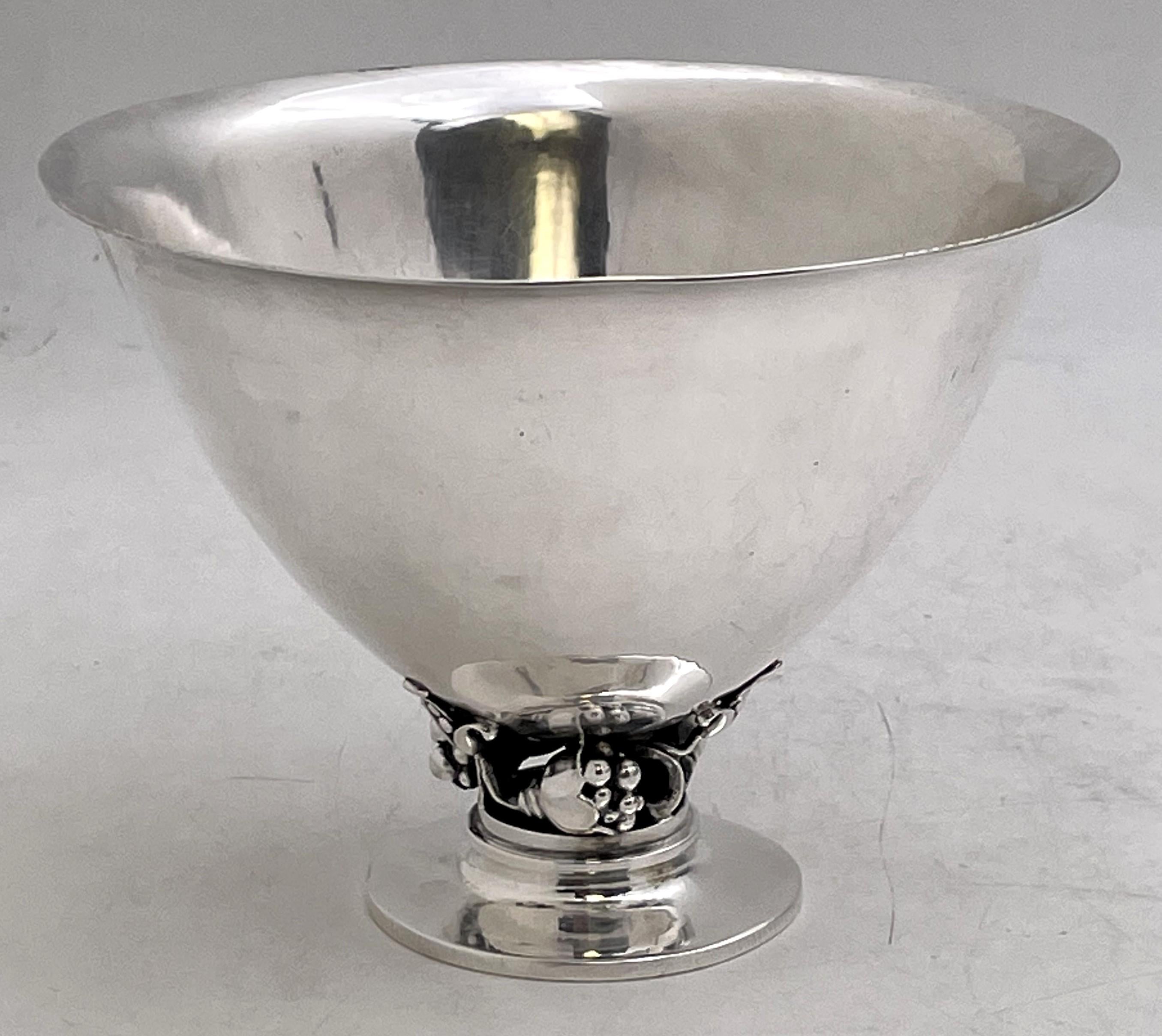 Georg Jensen sterling silver hand-hammered bowl, designed by Gundorph Albertus, in pattern number 778 and in Mid-Century Modern style, showcasing elegant floral and natural motifs at the base. It measures 5 3/4'' in diameter by 4 1/4'' in height,