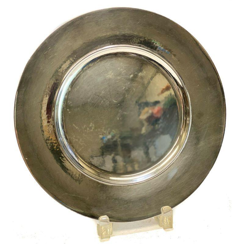 Georg Jensen sterling silver hand-hammered plate charger #587C, midcentury.

Georg Jensen mark to the underside.

Additional Information:
Material: Silver 
Brand: Georg Jensen
Pattern: Century 
Type: Plate
Dimension: 11 inches
