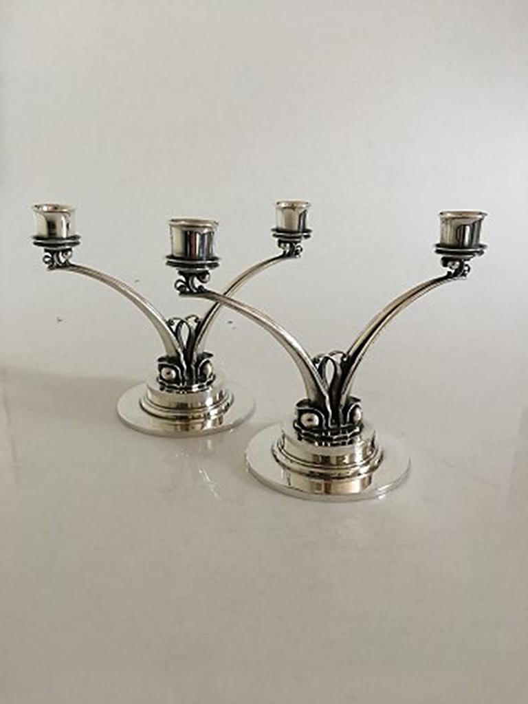 Georg Jensen sterling silver Harald Nielsen two-armed candlesticks no. 278. Measures: 15 cm H (5 29/32 in). Width 19.5 cm (7 43/64 in). These are made after 1945. In nice condition.
