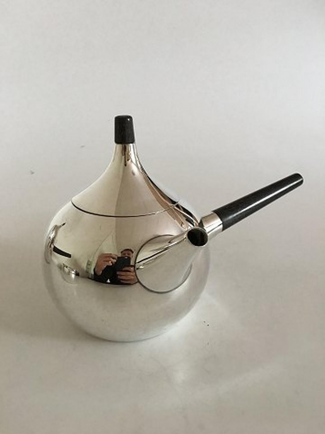 Georg Jensen sterling silver Henning Koppel coffee and teapot no. 1091. Both pots are with wooden handle and top. Coffee pot measures 11 cm H / 4 21/64