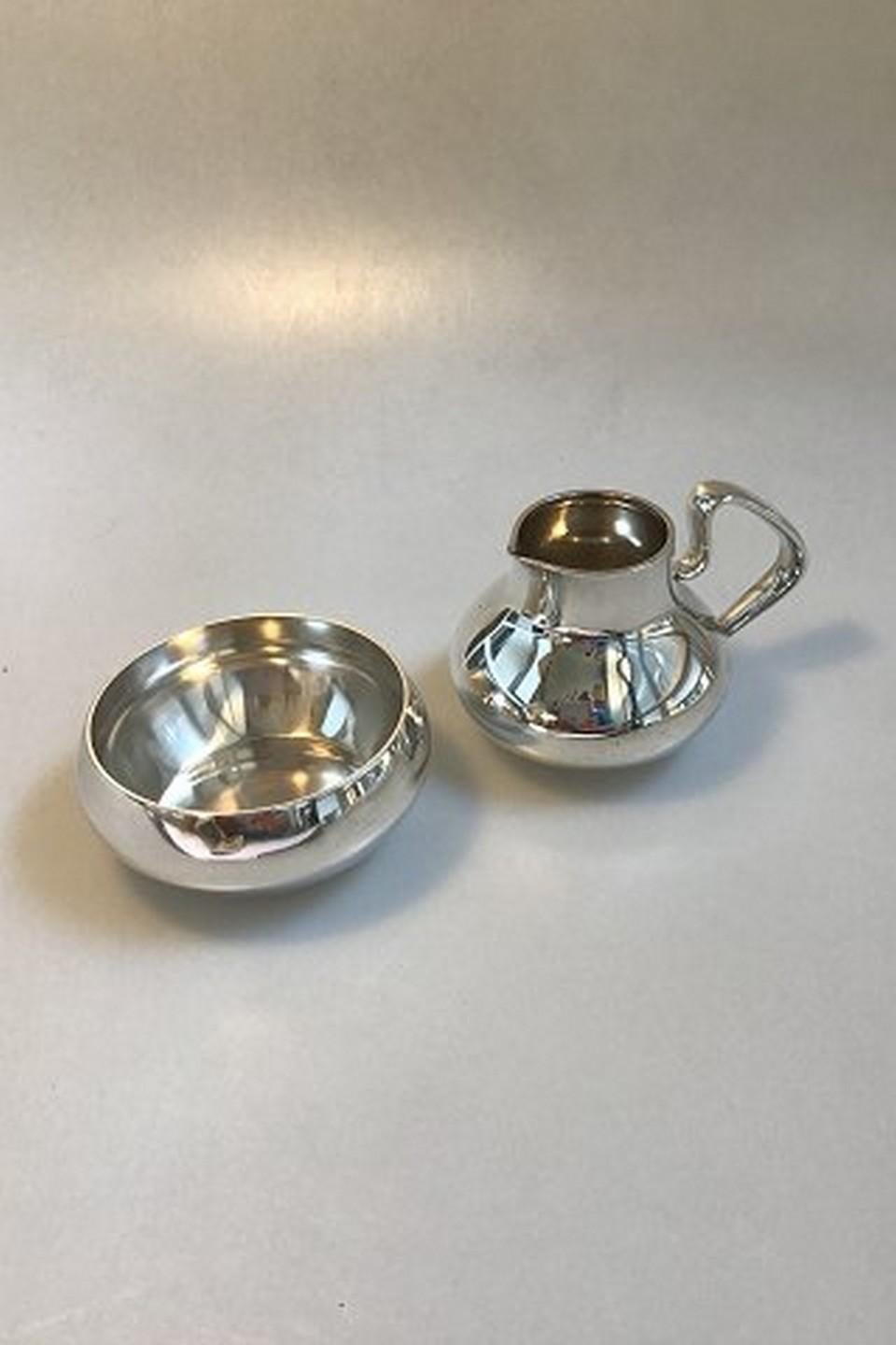 Georg Jensen sterling silver Henning Koppel tea and coffee set with tray no. 1017. The set is with old hallmarks. Teapot with Guaiacan handle, 12 cm H (4 23/32