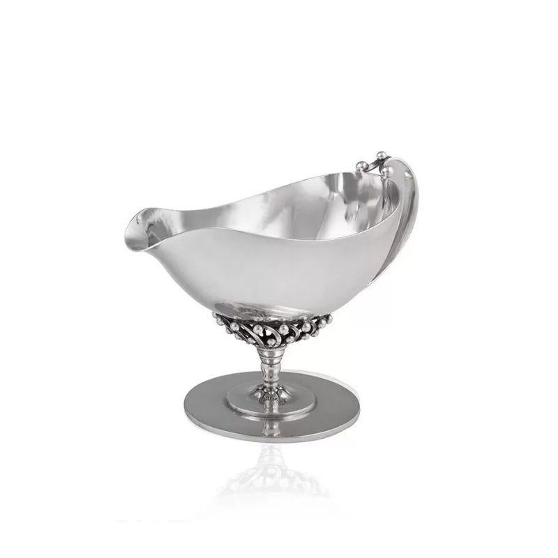 An extremally early vintage Danish Georg Jensen sterling silver large creamer, design #43 by Johan Rohde in 1914. A stemmed lidded boat that sits on a circular foot. The bowl is perched on spiral rods that are surrounded by silver balls. The base of