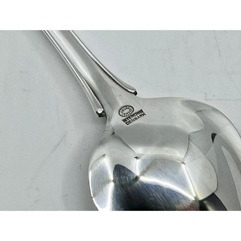 A Georg Jensen sterling silver triangular grapefruit spoon, item #075 in the Lily of the Valley pattern, design #1 by Georg Jensen from 1913. This pattern also called “Rose”, the Danish name is “Liljekonval”.

Additional information:
Material: