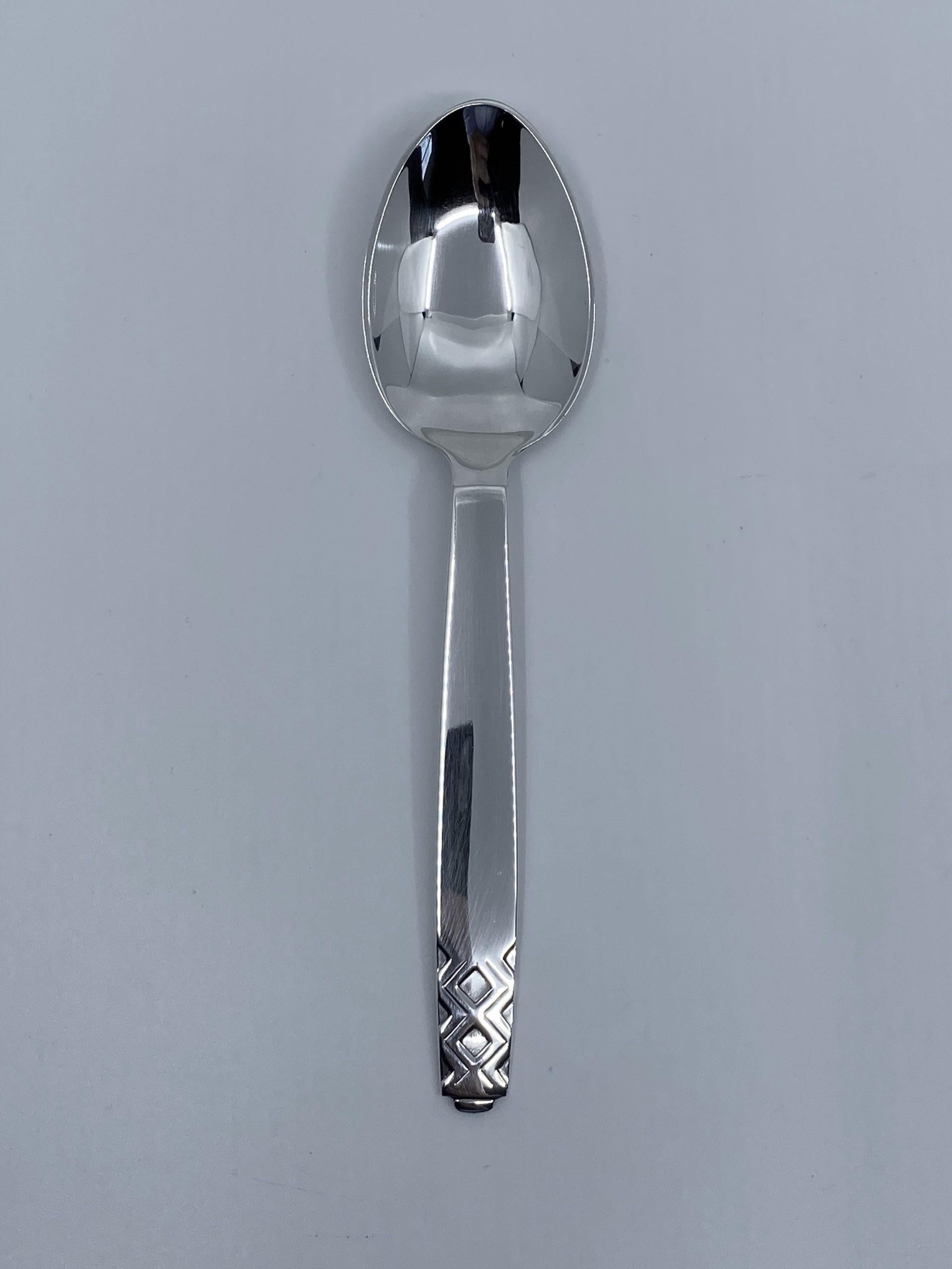 Sterling silver Georg Jensen dinner spoon, item 021 in the Mayan Pattern, design #56 by Johan Rohde from 1937.

Additional information:
Material: Sterling silver
Styles: Art Deco
Hallmarks: With Georg Jensen hallmark, made in Denmark.
Dimensions: