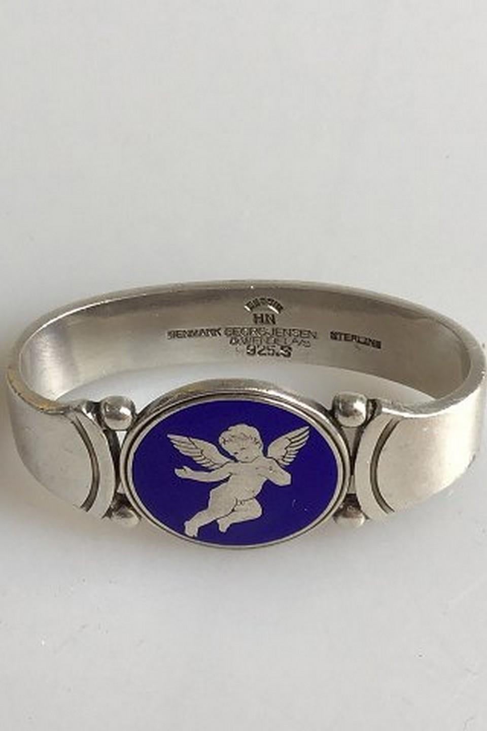 Georg Jensen sterling silver napkin ring little angel on blue enamel design Harald Nielsen (1945-1952) Measures: 4.5 cm / 1.77 in. x 2 cm / .78 in. Weighs 33.7 g /0.84 oz.
Item no.: 339663.