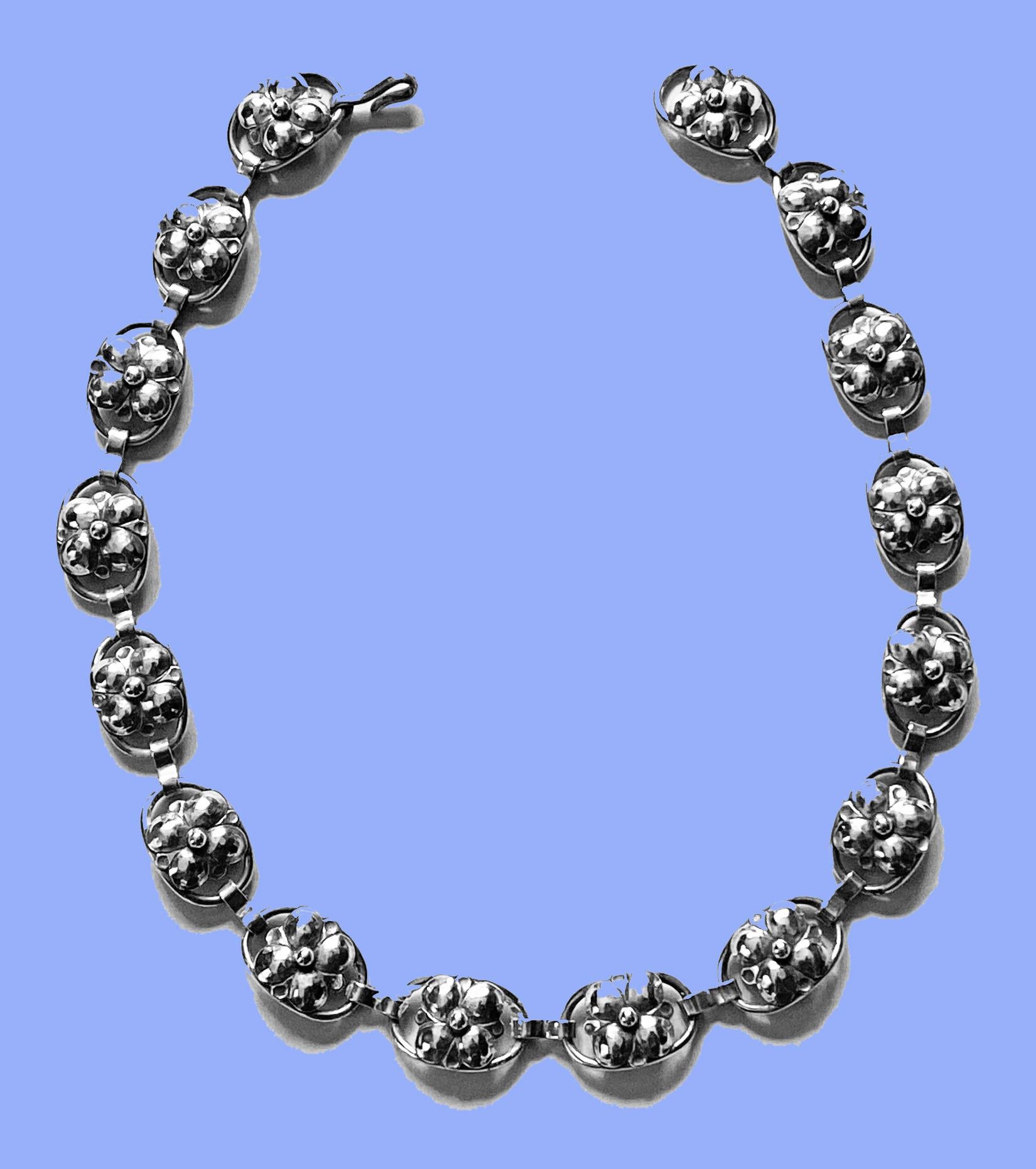 Georg Jensen Inc hand made Sterling Silver Necklace, American C.1940. The Necklace with sixteen organic rosette foliate bud motif links, hook fastener. Reverse with marks USA Georg Jensen Inc handwrought Sterling with design number 809A. Length: