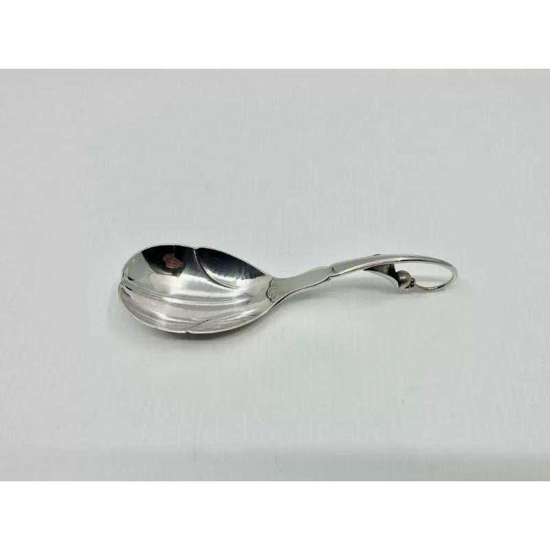 A sterling silver Georg Jensen compote spoon, the bowl of the spoon is chased into a stylistic leaf pattern, Ornamental pattern #21 by Georg Jensen from circa 1912. Ideal for use as a smaller serving spoon or for serving condiments.

Additional