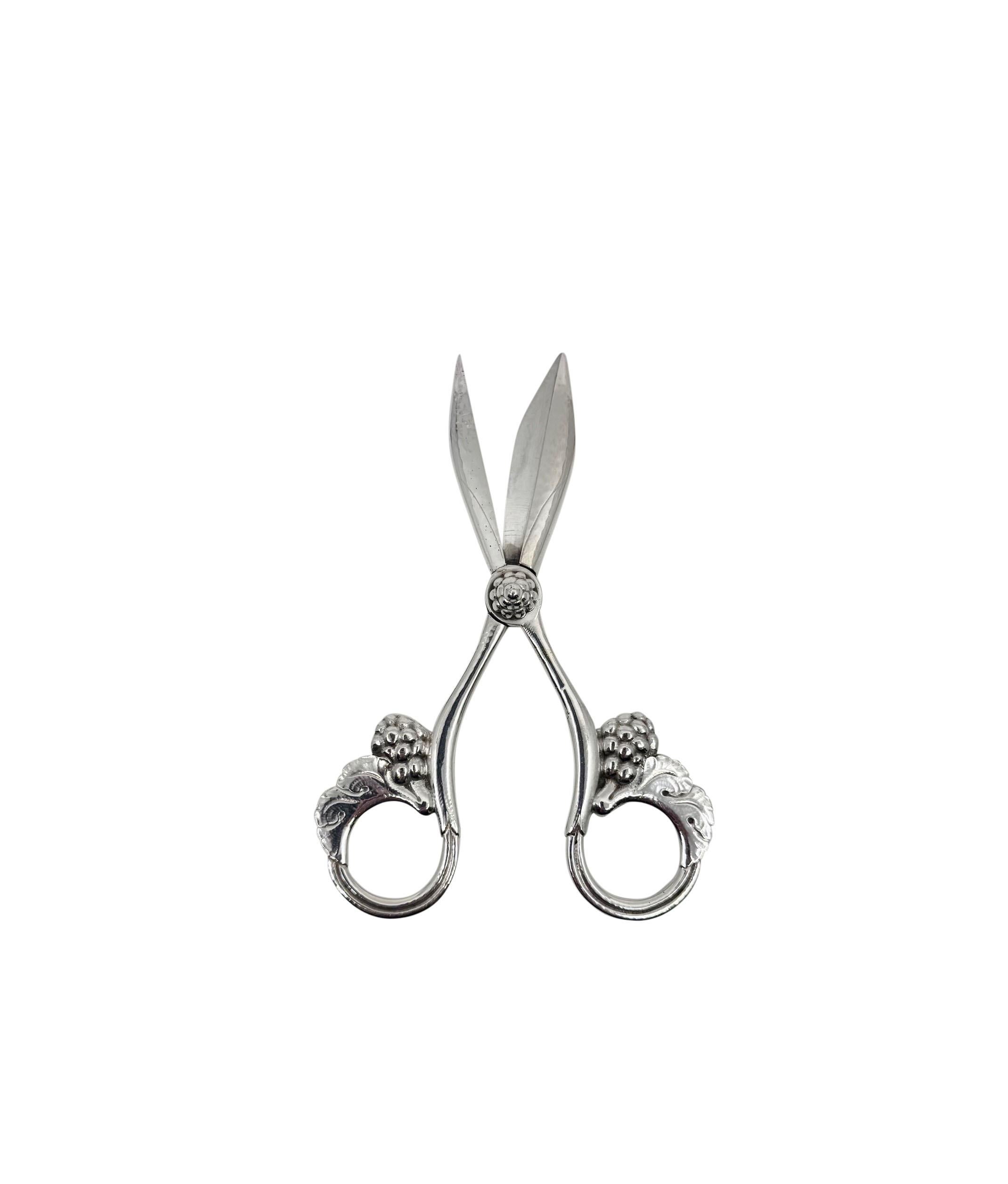 An early and rare sterling silver Georg Jensen grape shear, design #140 by Georg Jensen. These all silver grape shears have a great deal of detail including a hand chased bolt for the mechanism that holds the shears together.  A very nice heavy