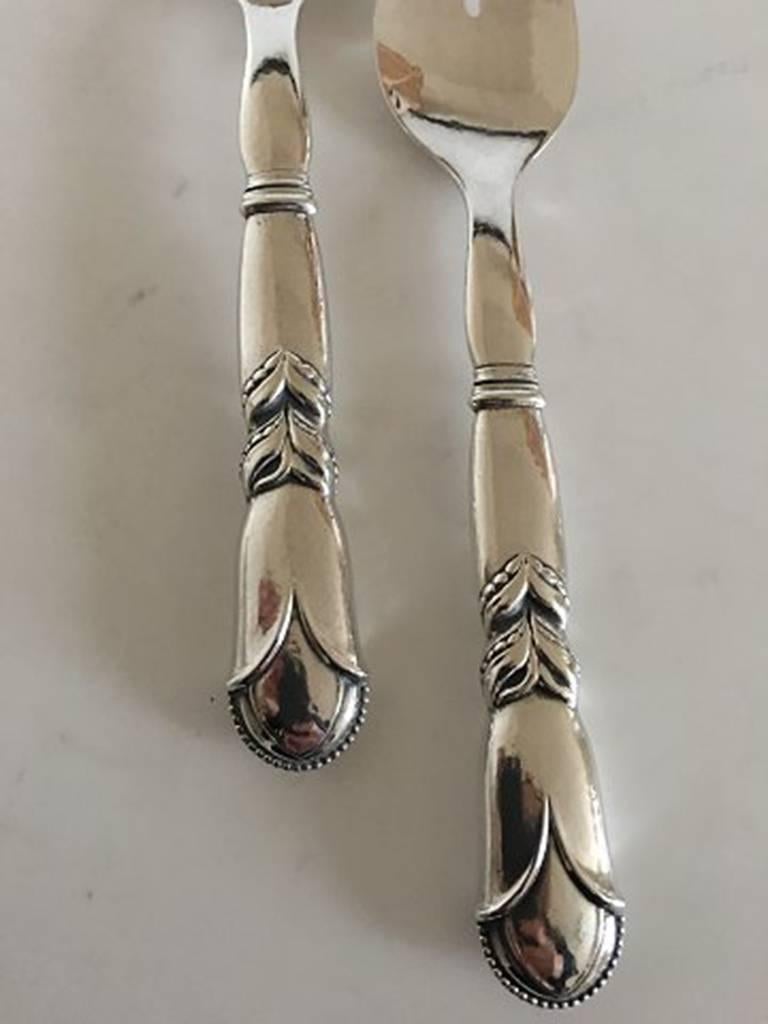 Georg Jensen sterling silver ornamental serving set no. 57. Spoon and fork measures 22 cm L (8 21/32 in.). Manufactured after 1945.